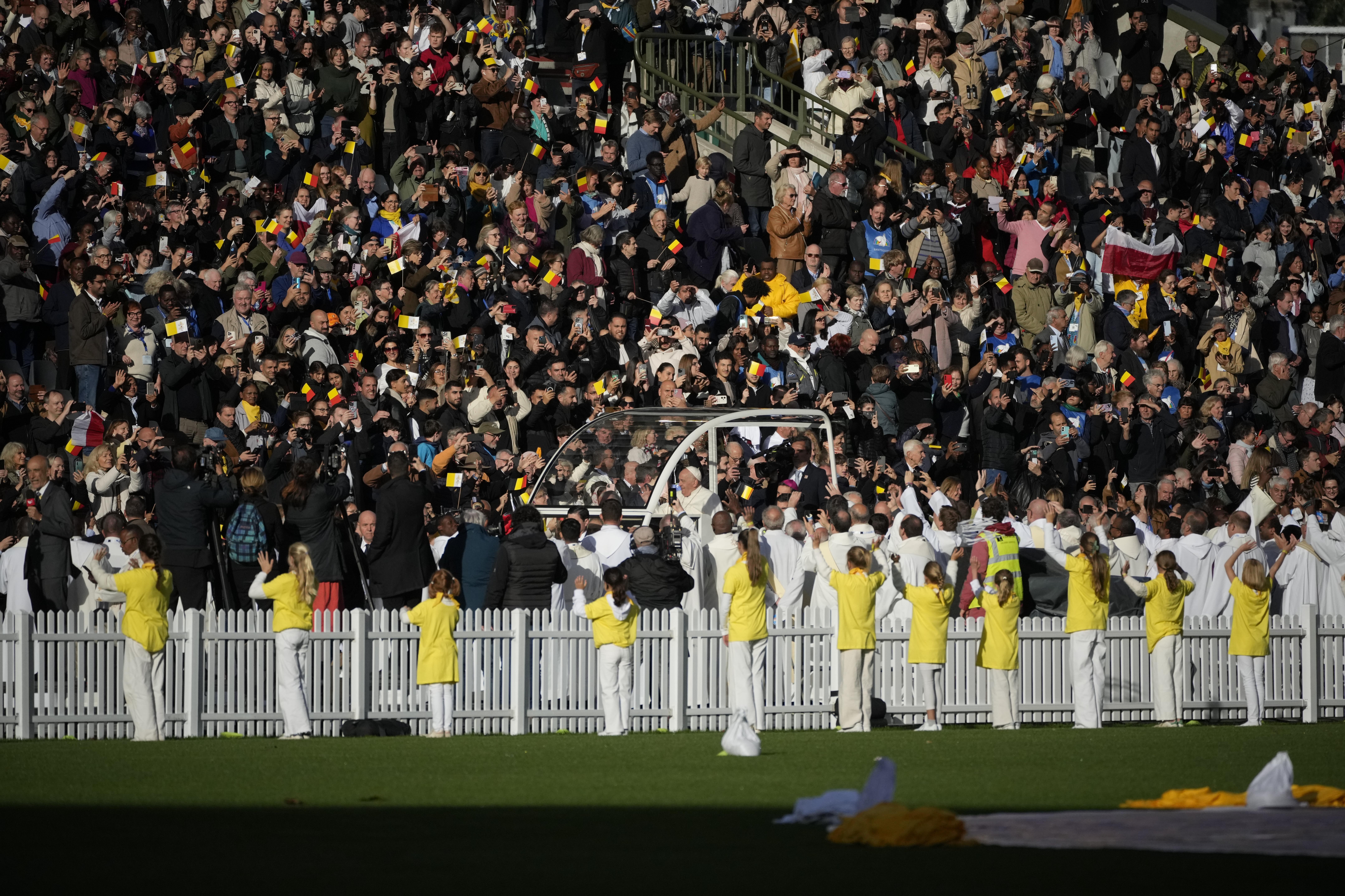 Pope Francis is cheered by faithful as he arrives to preside over the Sunday mass in King Baudouin Stadium, in Brussels Sunday, Sept. 29, 2024. (AP Photo/Andrew Medichini)