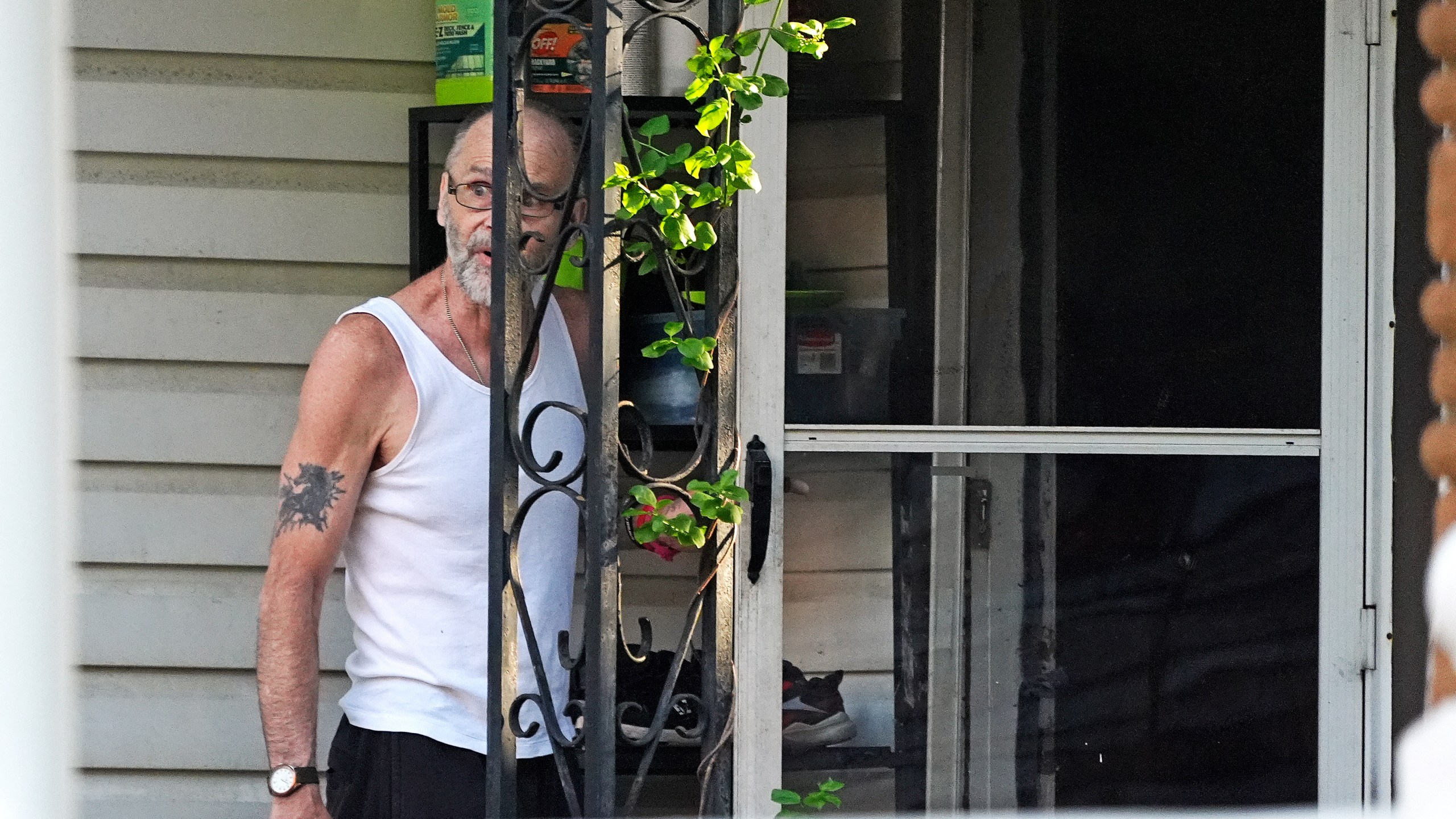 Ernie Bevilacqua declines to talk to a reporter after answering his door at his home in Greensburg, Pa., on April 29, 2024. Bevilacqua is among four jailhouse informants whose testimony put Steve Szarewicz behind bars for life on a murder conviction. (AP Photo/Gene J. Puskar)