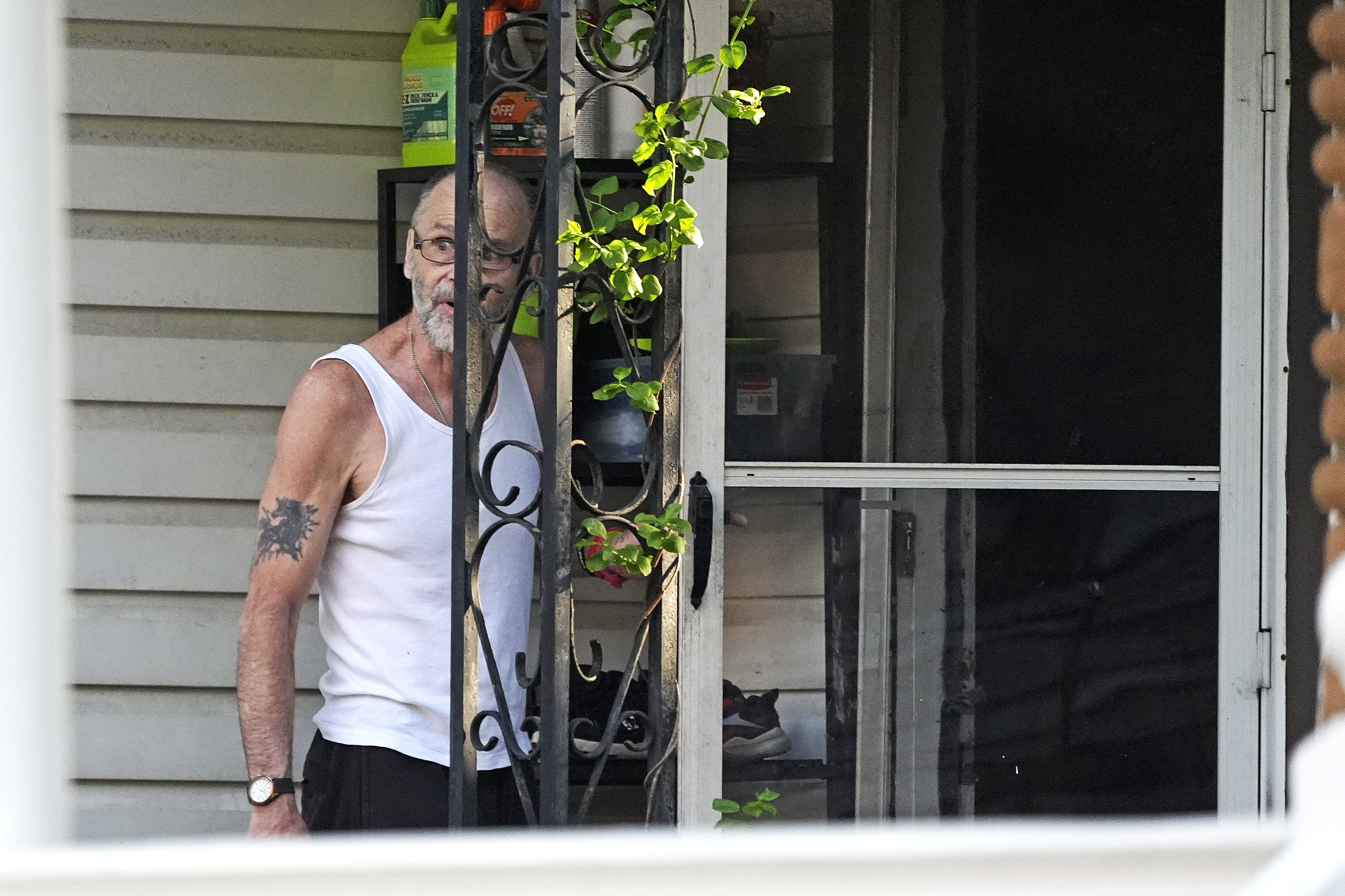 Ernie Bevilacqua declines to talk to a reporter after answering his door at his home in Greensburg, Pa., on April 29, 2024. Bevilacqua is among four jailhouse informants whose testimony put Steve Szarewicz behind bars for life on a murder conviction. (AP Photo/Gene J. Puskar)