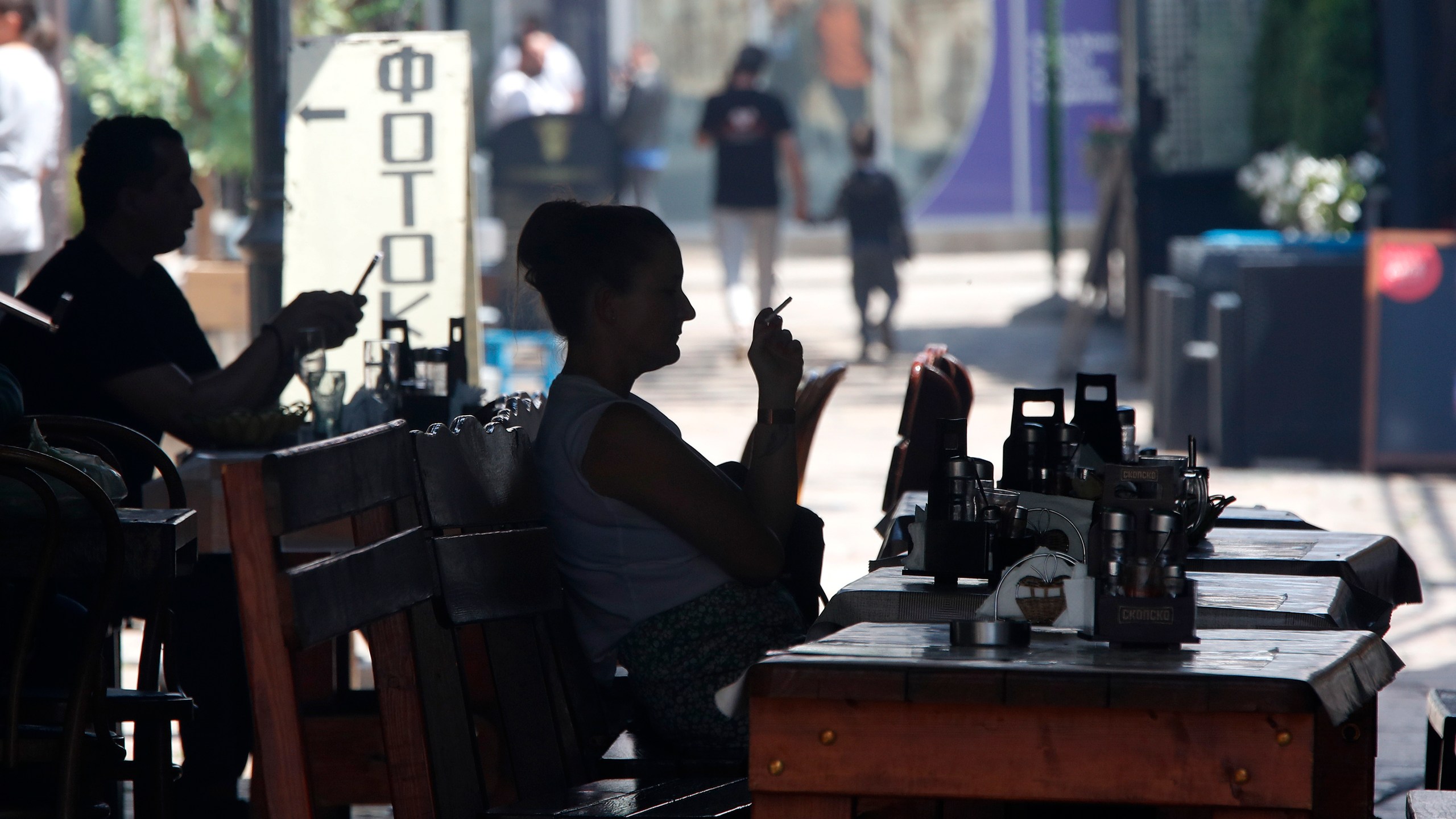 FILE - People sit in a restaurant in a street in the Old Bazaar, a day after the presidential and parliamentary elections, in Skopje, North Macedonia, on May 9, 2024. (AP Photo/Boris Grdanoski, File)