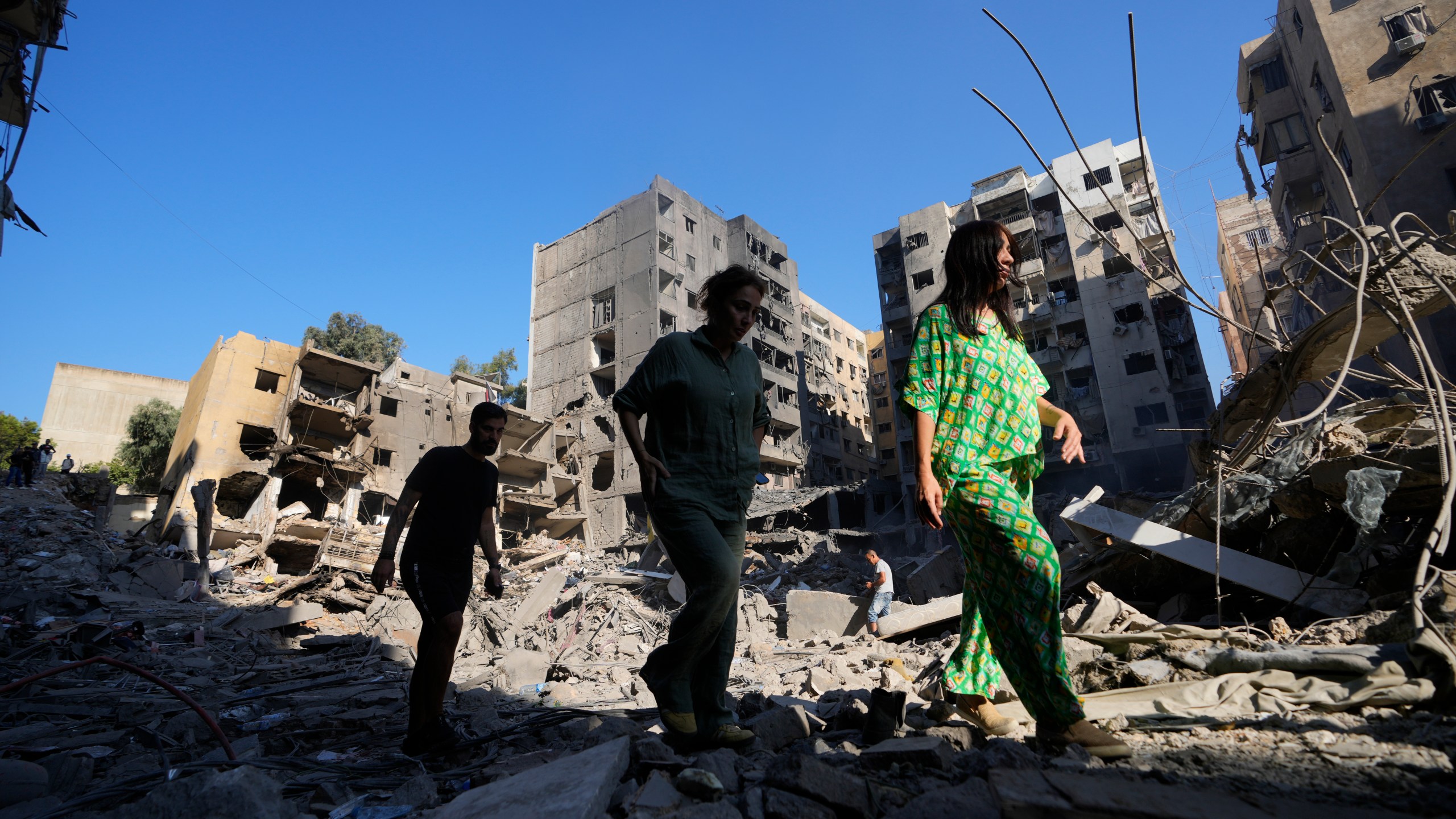 People check the site of the assassination of Hezbollah leader Hassan Nasrallah in Beirut's southern suburbs, Sunday, Sept. 29, 2024. (AP Photo/Hassan Ammar)