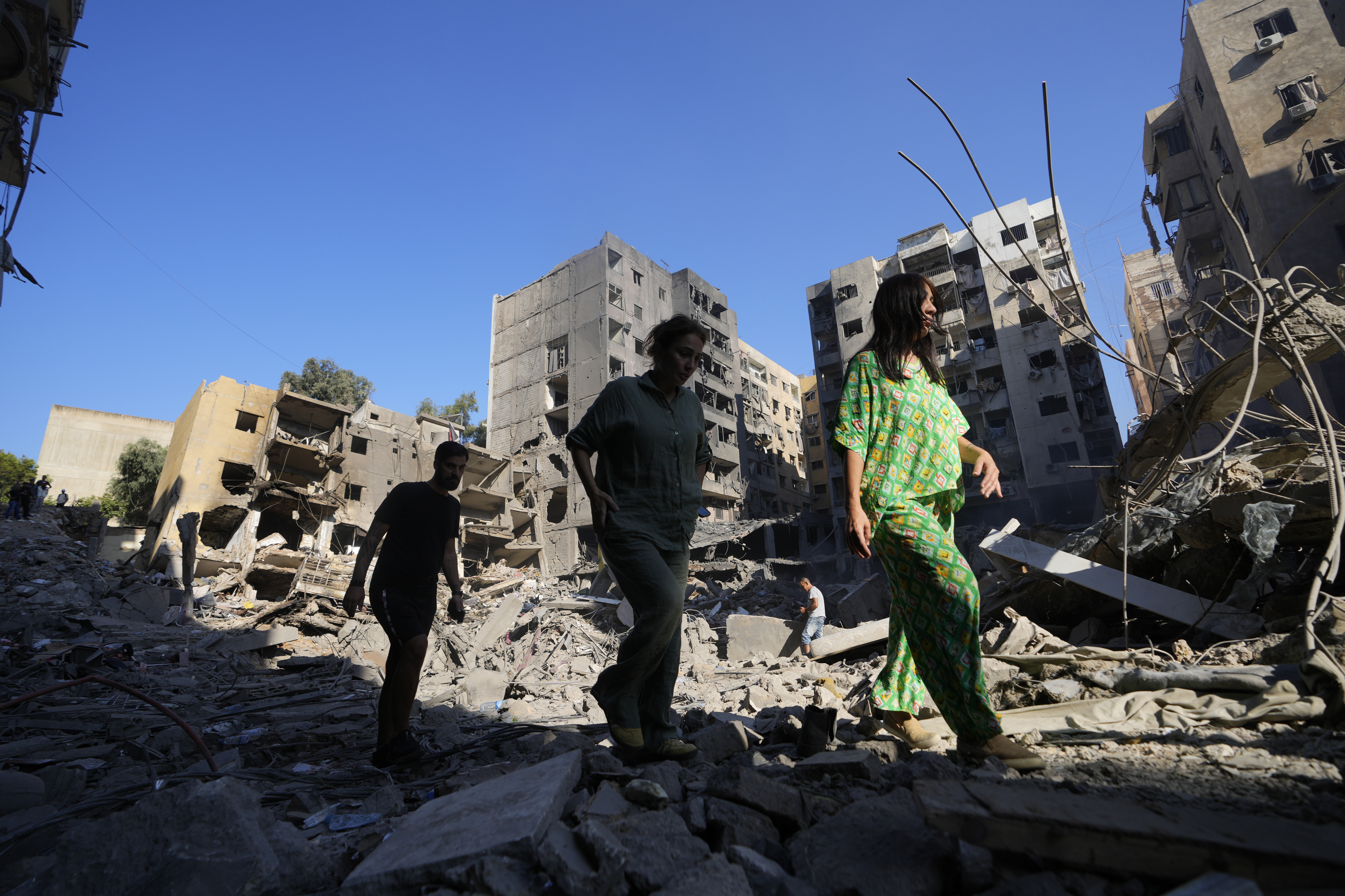 People check the site of the assassination of Hezbollah leader Hassan Nasrallah in Beirut's southern suburbs, Sunday, Sept. 29, 2024. (AP Photo/Hassan Ammar)