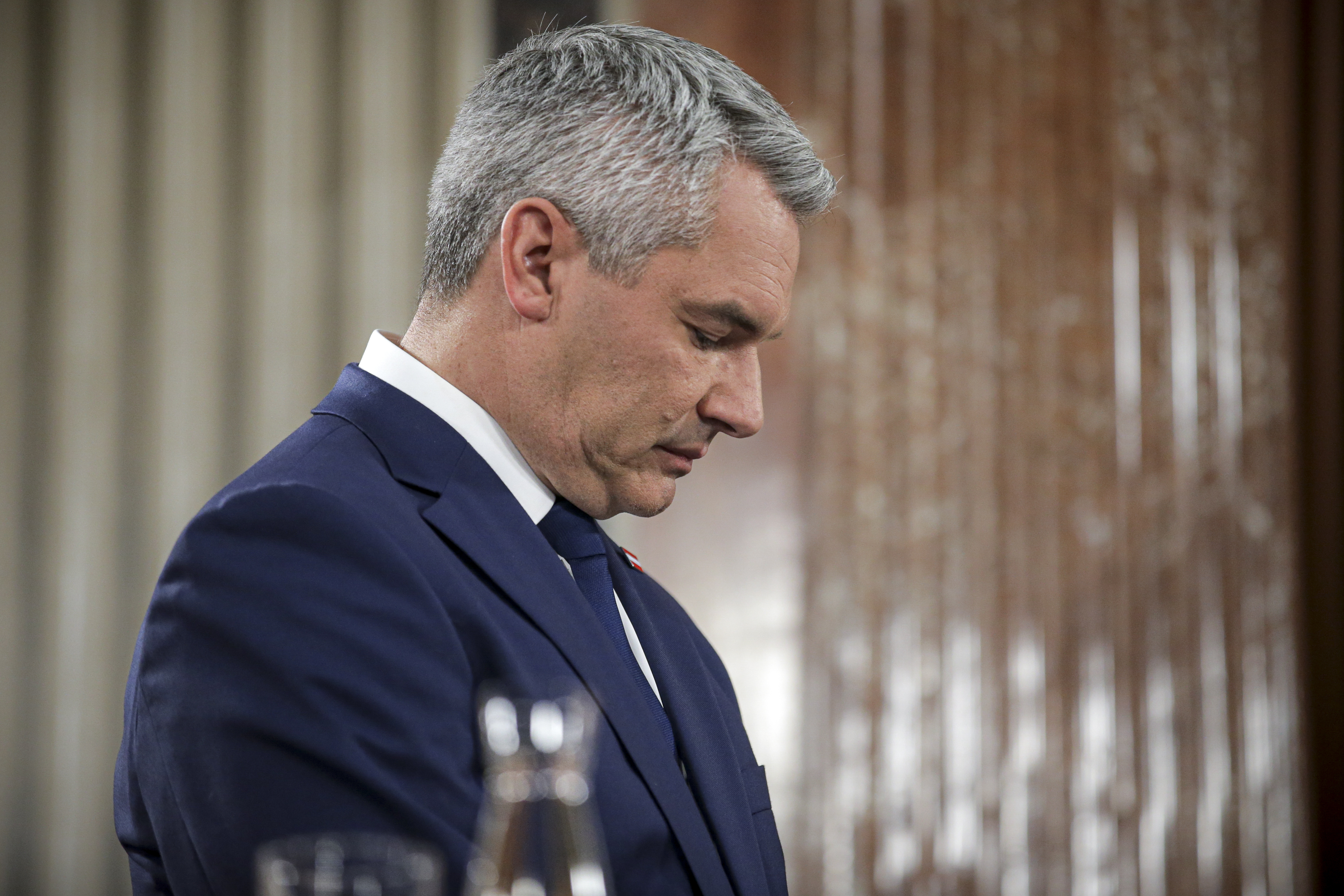 Austrian Chancellor Karl Nehammer stands at the national broadcaster studio, set up in the parliament building, in Vienna, Austria, Sunday, Sept. 29, 2024, after polls closed in the country's national election. (AP Photo/Heinz-Peter Bader)