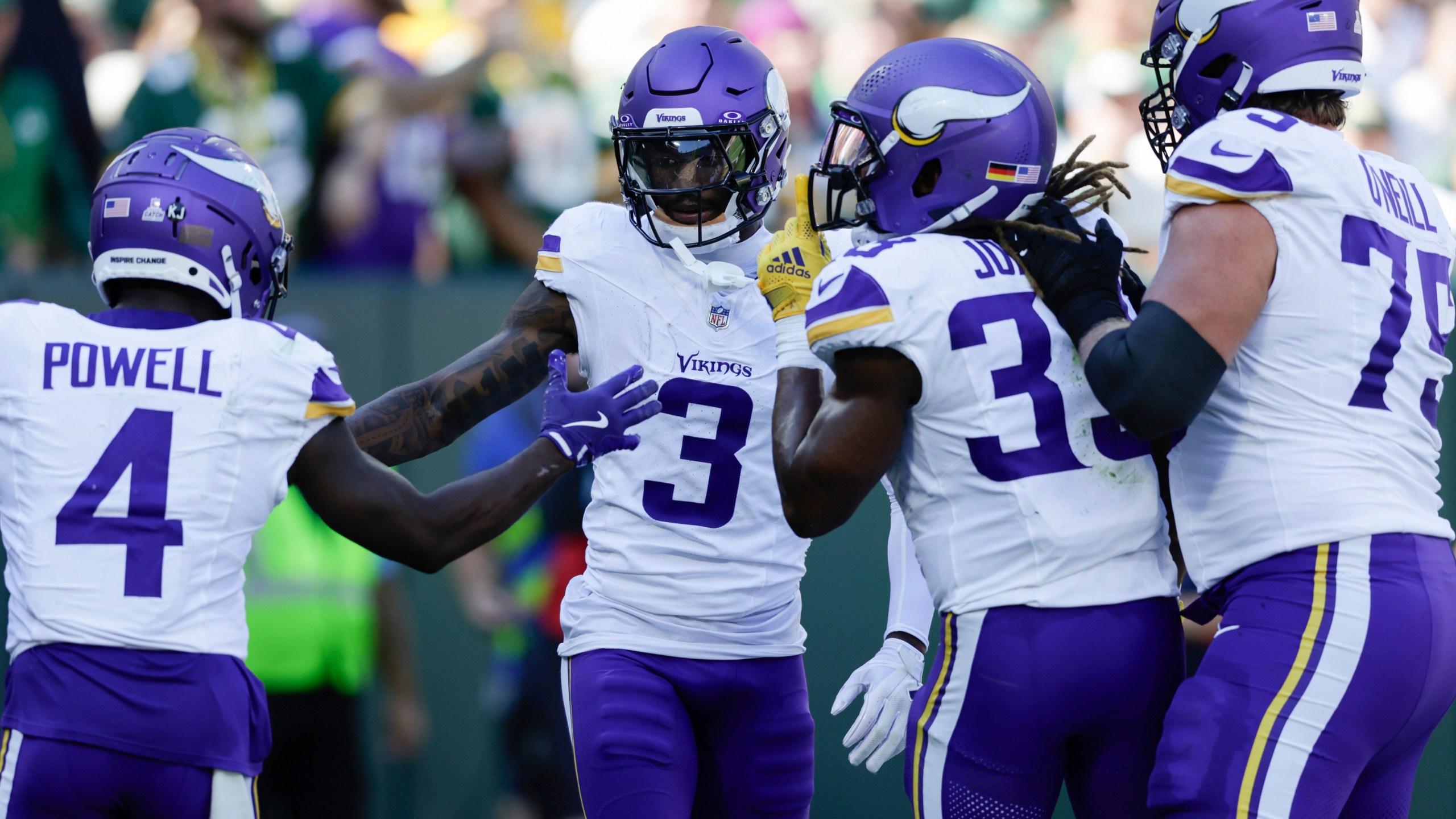 Minnesota Vikings wide receiver Jordan Addison (3) celebrates his touchdown with teammates, Brandon Powell (4), Aaron Jones (33) and Tyrese Robinson (79) during the first half of an NFL football game against the Green Bay Packers, Sunday, Sept. 29, 2024, in Green Bay, Wis. (AP Photo/Matt Ludtke)