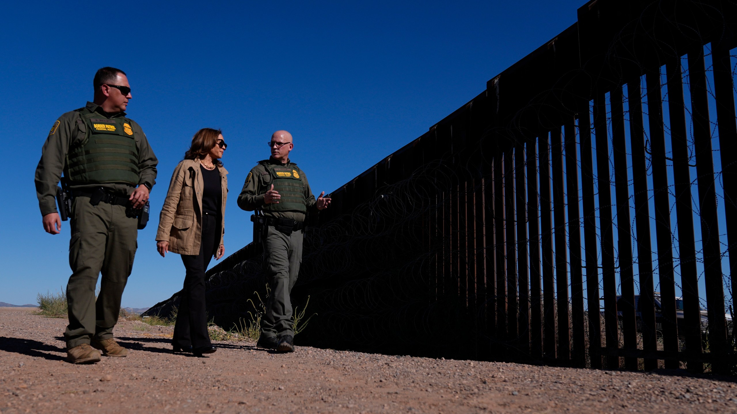 Democratic presidential nominee Vice President Kamala Harris talks with John Modlin, the chief patrol agent for the Tucson Sector of the U.S. Border Patrol, right, and Blaine Bennett, the U.S. Border Patrol Douglas Station border patrol agent in charge, as she visits the U.S. border with Mexico in Douglas, Ariz., Friday, Sept. 27, 2024. (AP Photo/Carolyn Kaster)