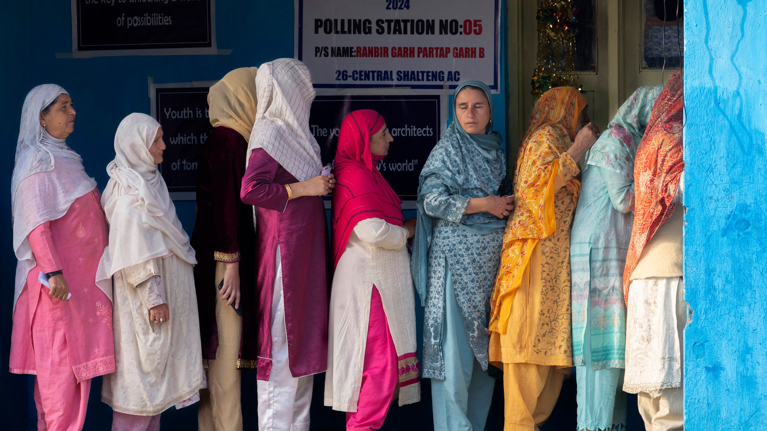 FILE- Kashmiri women queue up at a polling booth to cast their vote during the second phase of the assembly election in the outskirts of Srinagar, Indian controlled Kashmir, Sept. 25, 2024. (AP Photo/Dar Yasin, File)