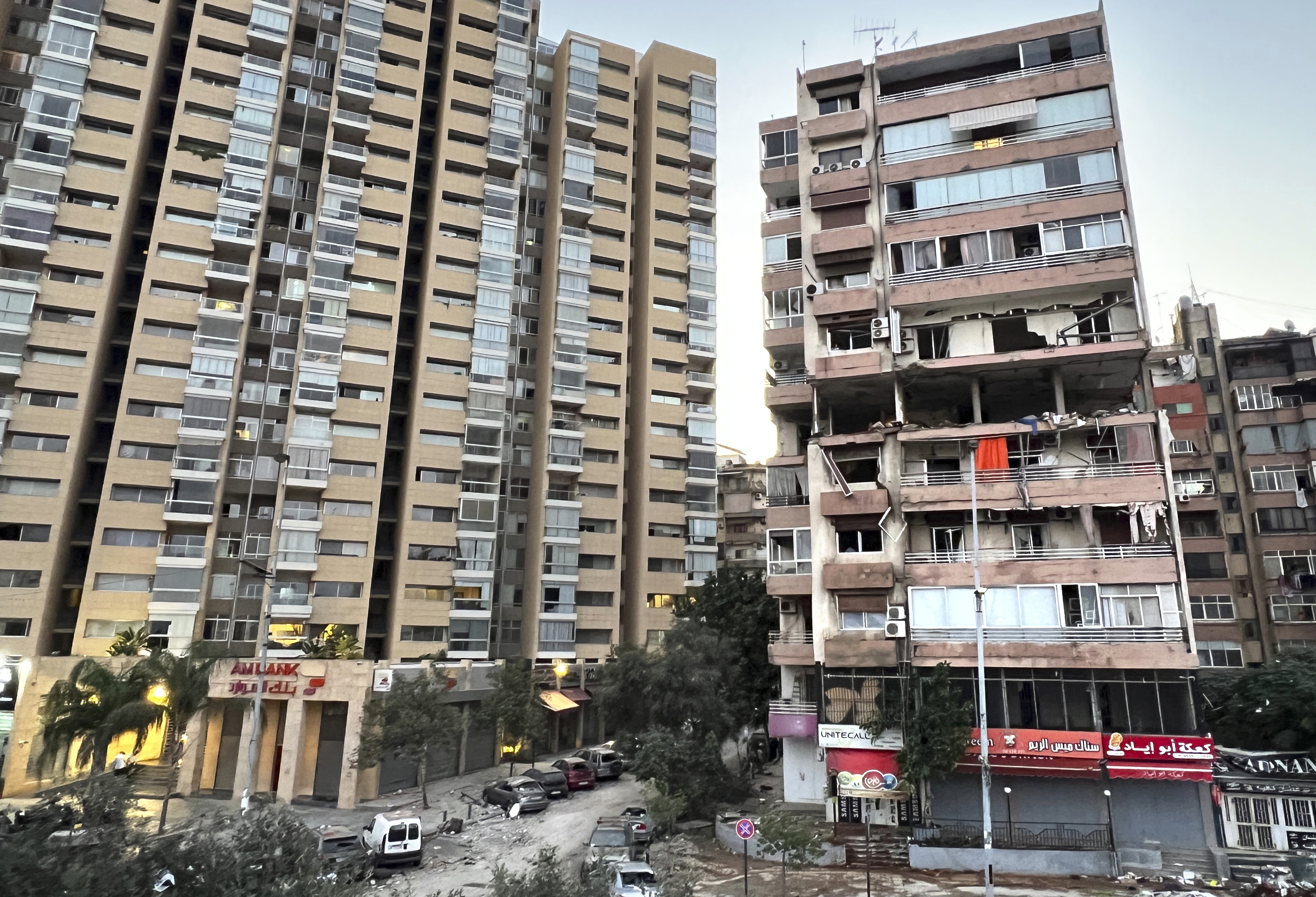 Damaged apartments, right, are seen in a building that was hit by Israeli strike, in Beirut, Lebanon, early Monday, Sept. 30, 2024. (AP Photo/Hussein Malla)