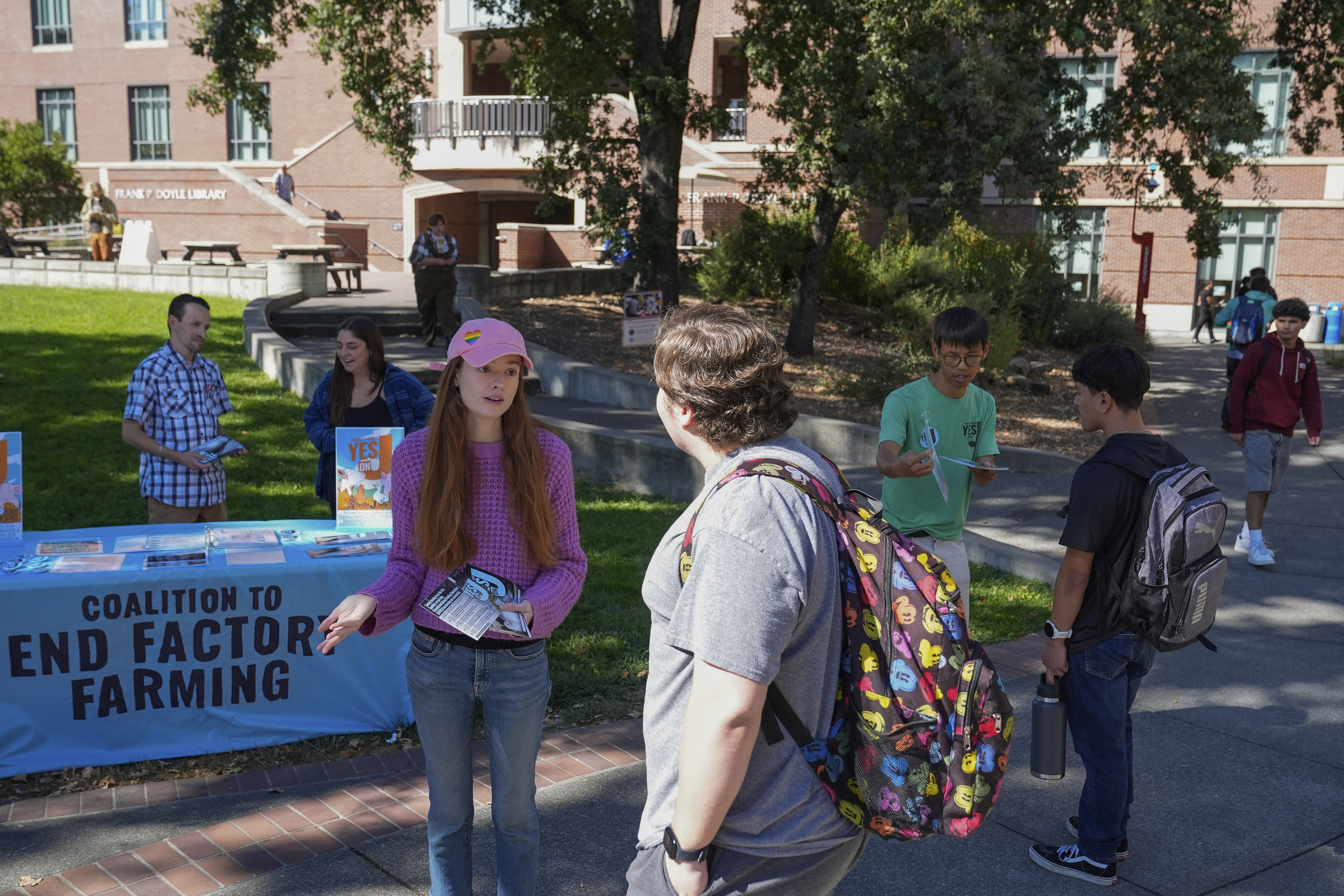 Cassie King, center left, talks to a student at Santa Rosa Junior College about voting yes on Measure J, Monday, Sept. 23, 2024, in Santa Rosa, Calif. (AP Photo/Godofredo A. Vásquez)