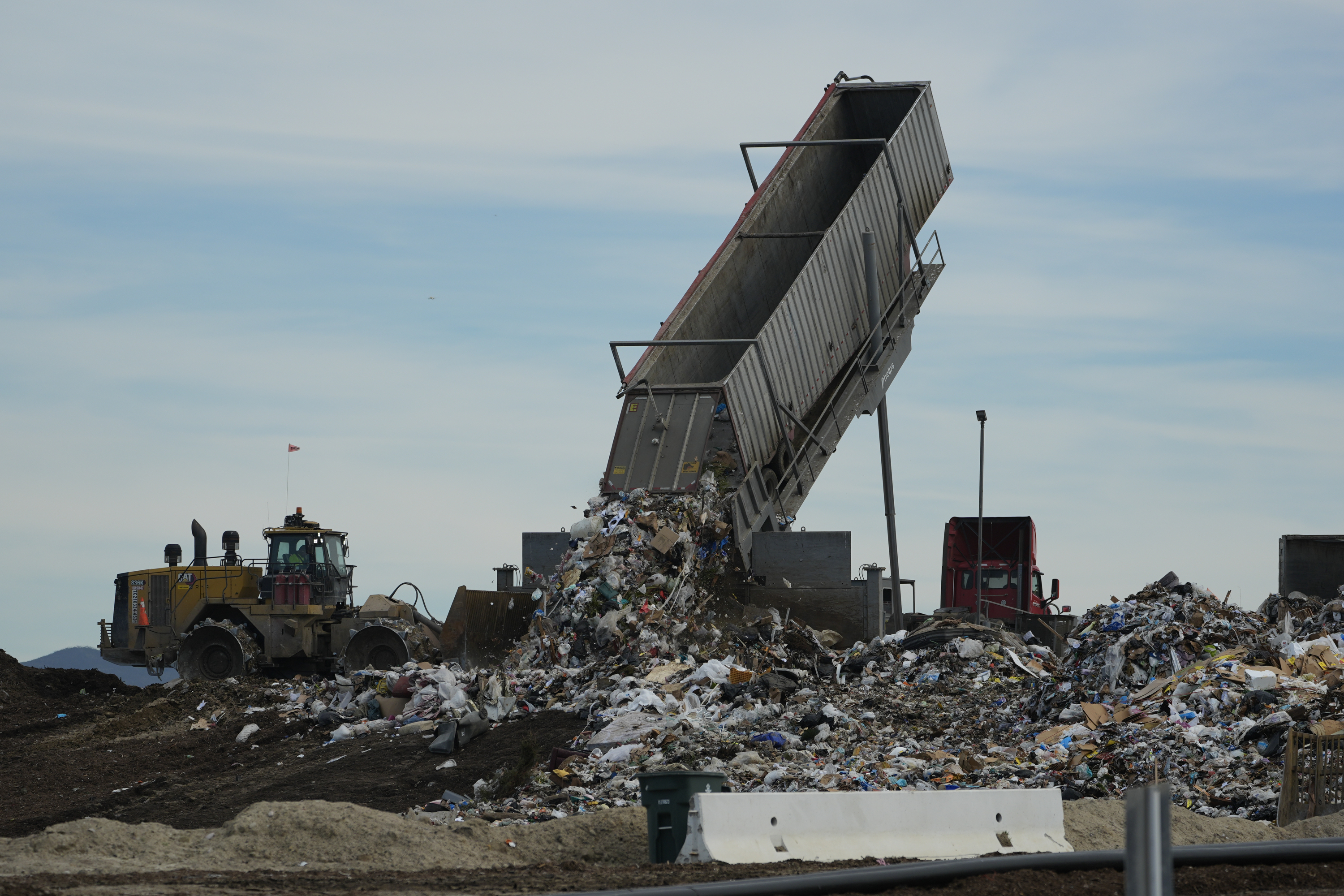 FILE - Trash is unloaded at the Otay Landfill in Chula Vista, Calif., Jan. 26, 2024. (AP Photo/Damian Dovarganes, File)