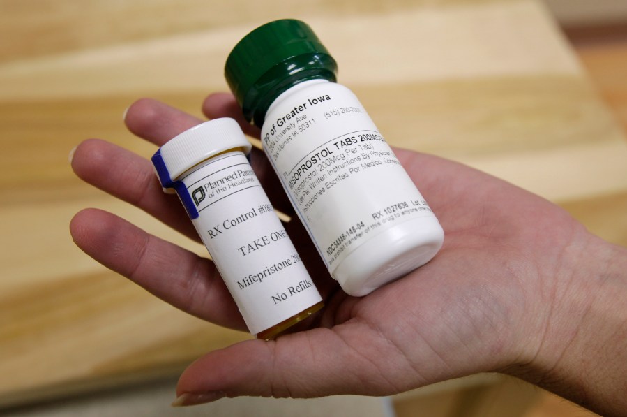 FILE - Bottles of abortion pills mifepristone, left, and misoprostol, right, are displayed at a clinic in Des Moines, Iowa, Sept. 22, 2010. (AP Photo/Charlie Neibergall, File)