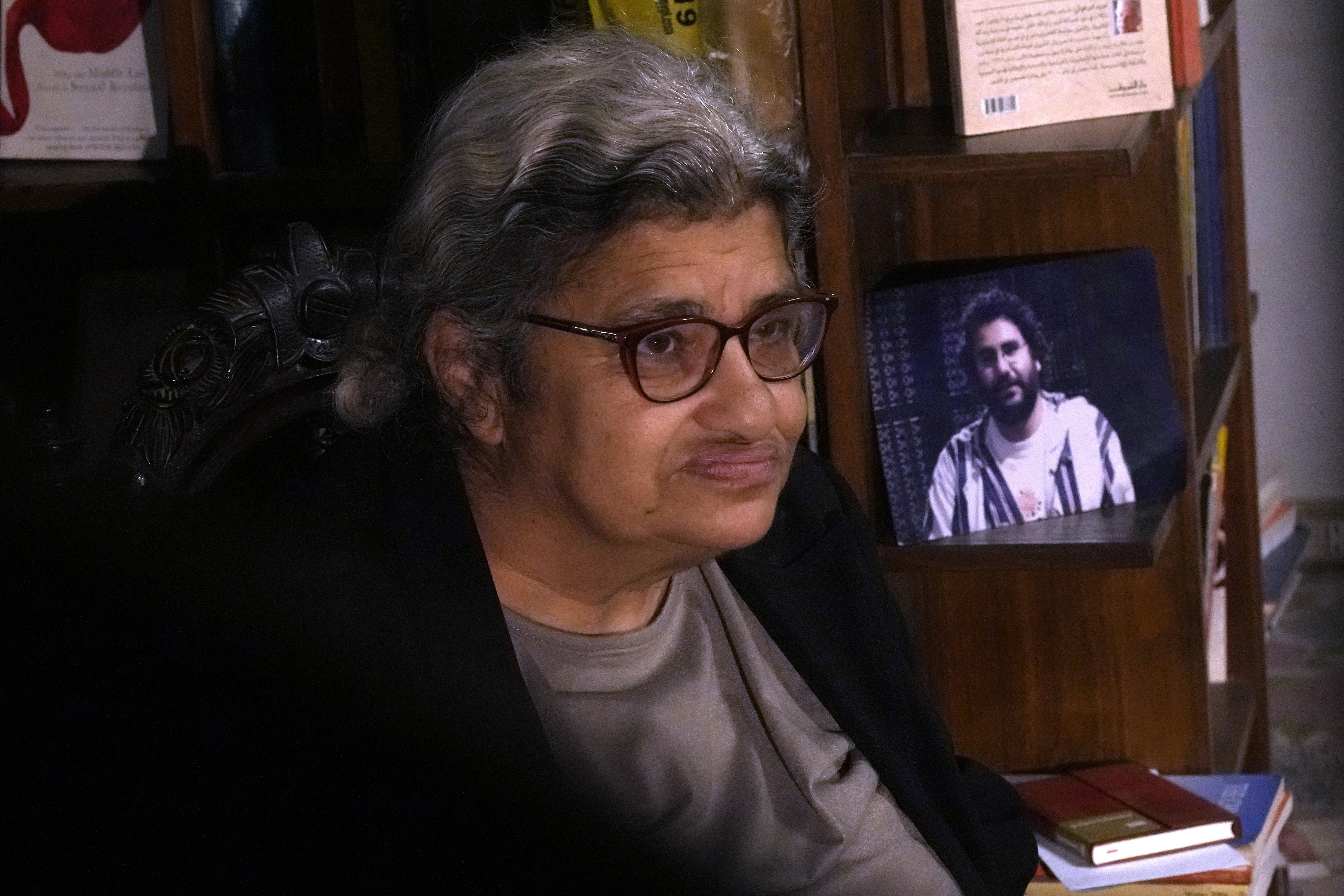 FILE - Laila Soueif, mother of jailed pro-democracy activist Alaa Abdel-Fattah, speaks during an interview with the Associated Press in front of his picture at her home in Cairo, Egypt, Thursday, Nov. 10, 2022. (AP Photo/Amr Nabil, File)