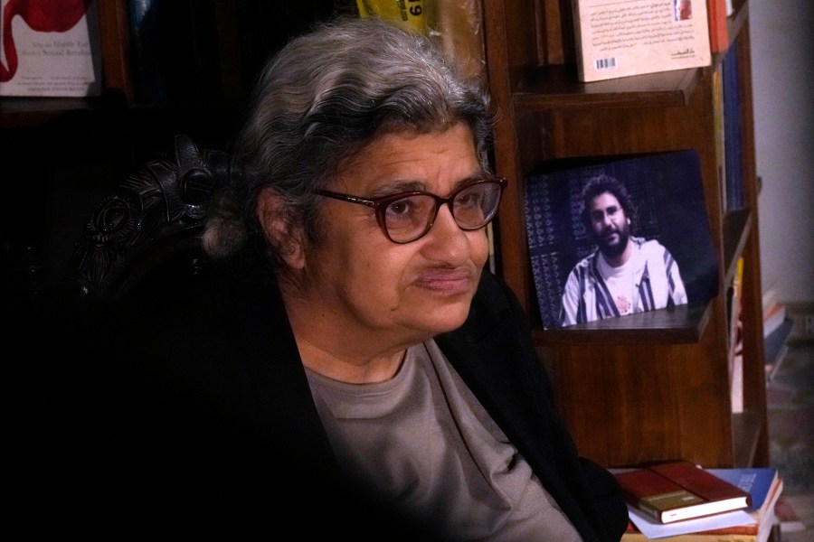 FILE - Laila Soueif, mother of jailed pro-democracy activist Alaa Abdel-Fattah, speaks during an interview with the Associated Press in front of his picture at her home in Cairo, Egypt, Thursday, Nov. 10, 2022. (AP Photo/Amr Nabil, File)