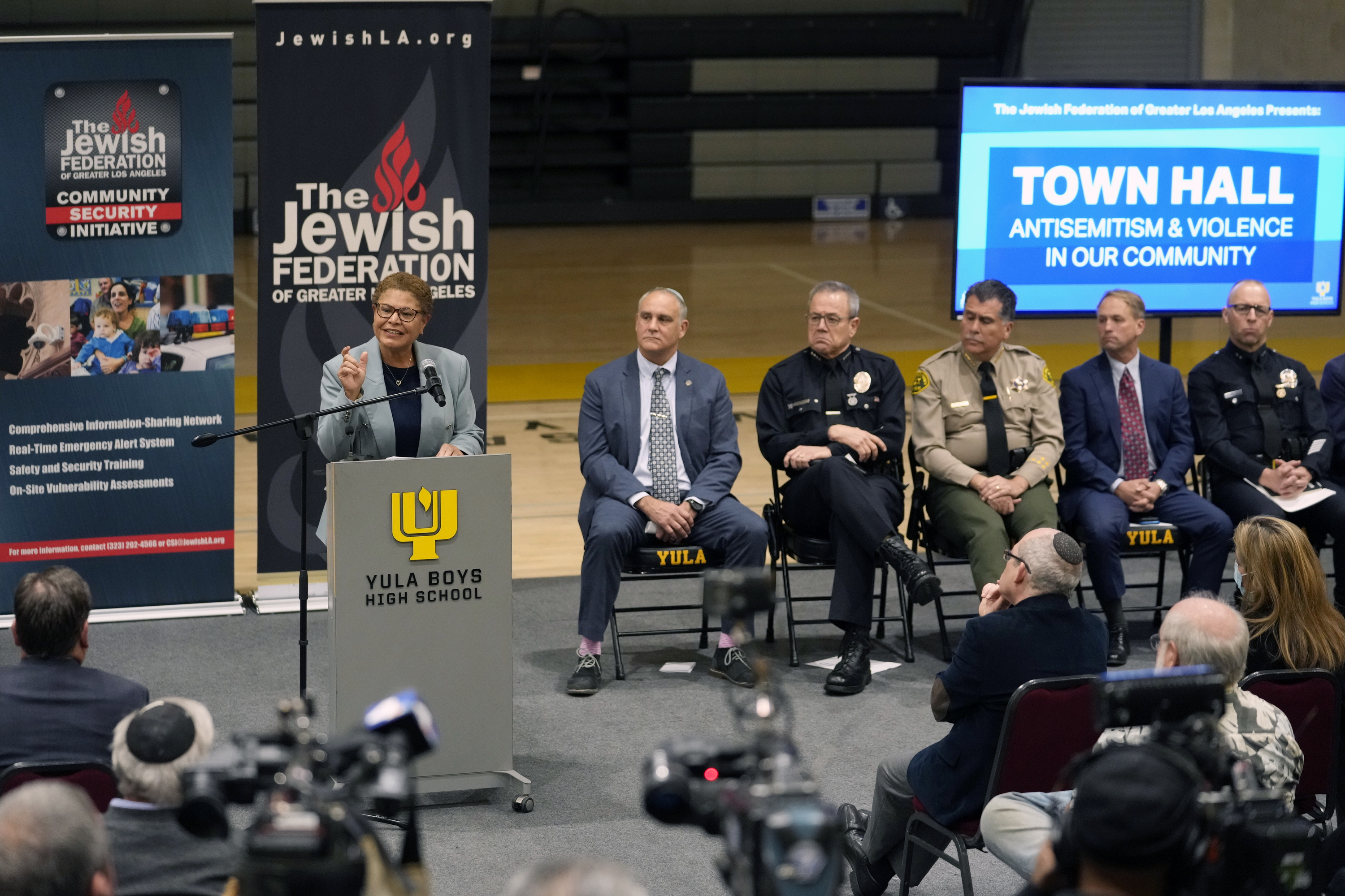 FILE - Los Angeles Mayor Karen Bass, at podium, addresses community members and other local, state law enforcement officials in a town hall on antisemitic violence at YULA Boys High School in Los Angeles Monday, Feb. 20, 2023. (AP Photo/Damian Dovarganes, File)