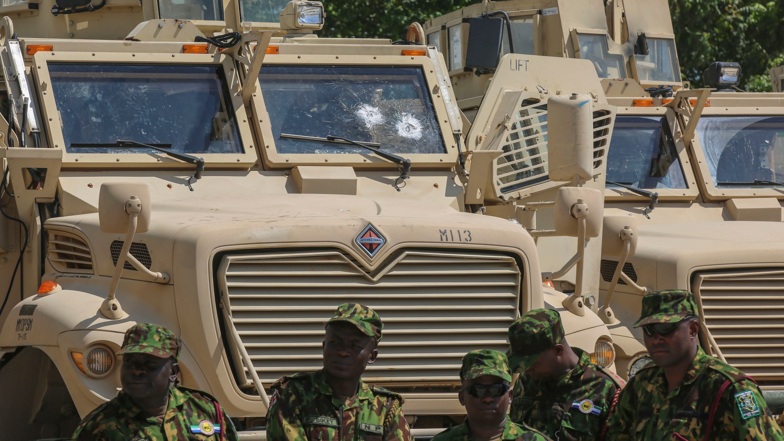 Kenyan police officers, part of a UN-backed multinational force, stand next to armored vehicles on their base during a visit by Kenya's President William Ruto, in Port-au-Prince, Haiti, Saturday, Sept. 21, 2024. (AP Photo/Odelyn Joseph)