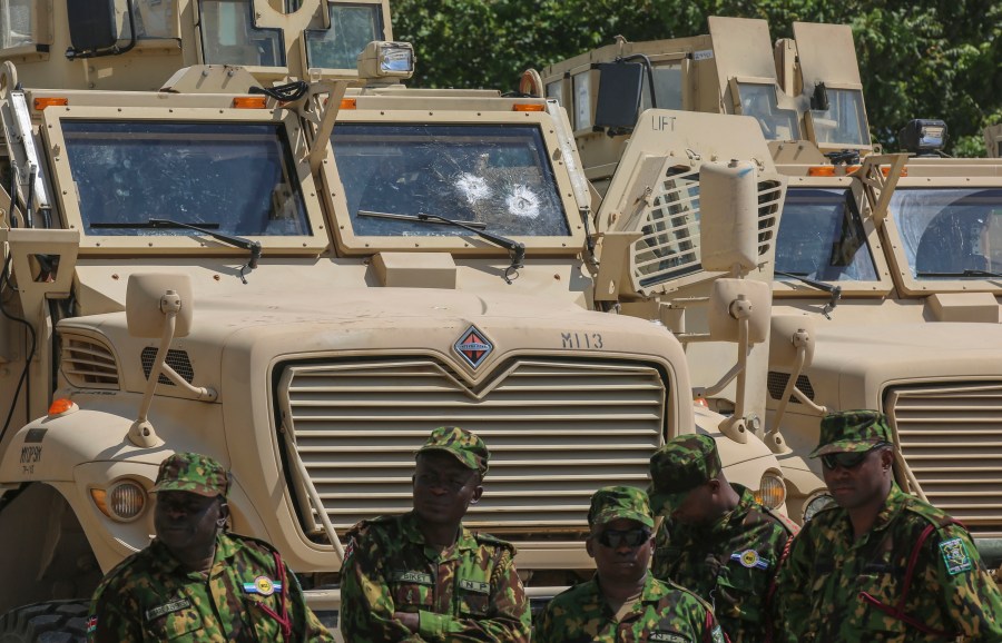 Kenyan police officers, part of a UN-backed multinational force, stand next to armored vehicles on their base during a visit by Kenya's President William Ruto, in Port-au-Prince, Haiti, Saturday, Sept. 21, 2024. (AP Photo/Odelyn Joseph)