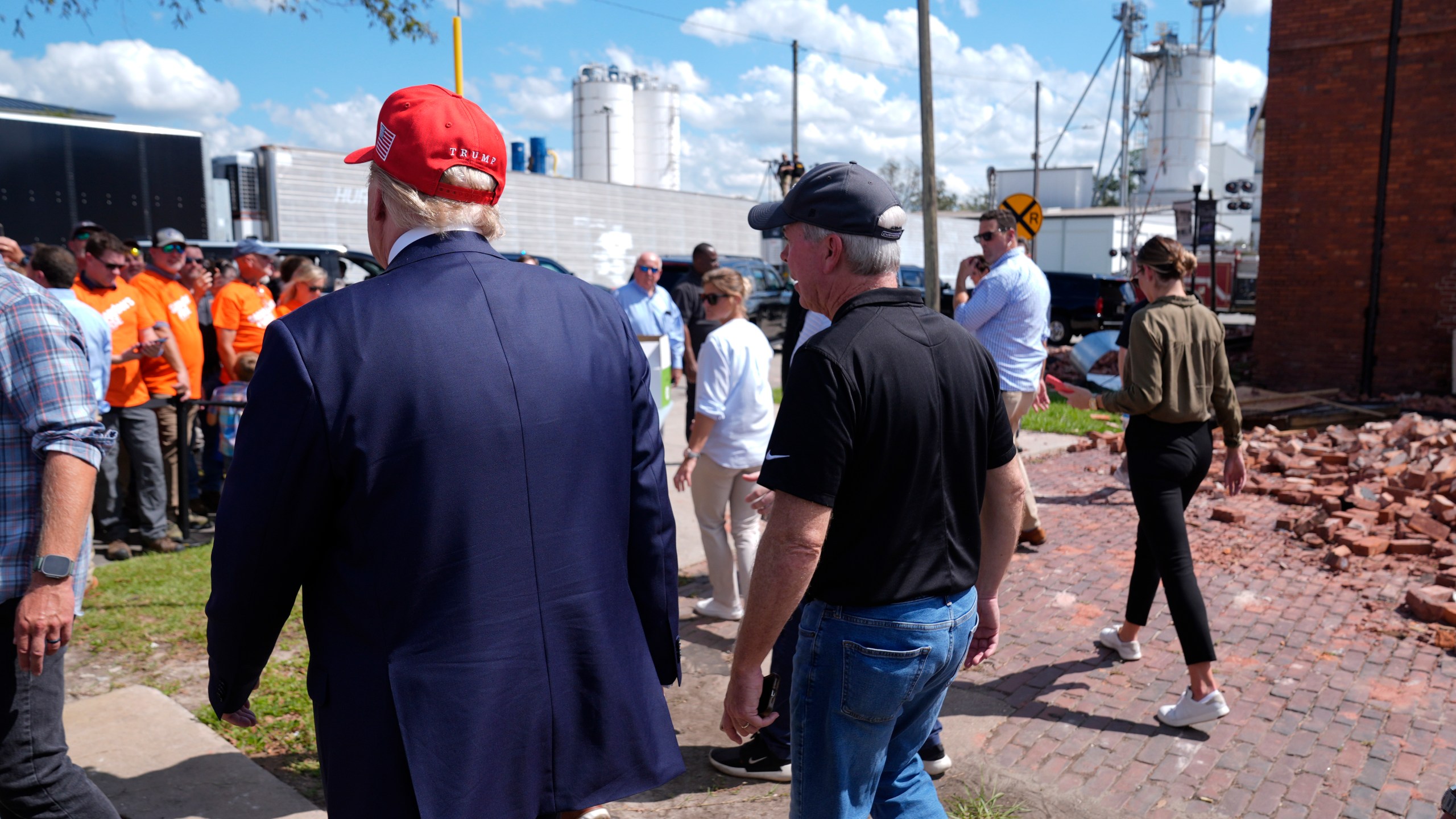 Republican presidential nominee former President Donald Trump walks outside the Chez What furniture store as he visits Valdosta, Ga., a town impacted by Hurricane Helene, Monday, Sept. 30, 2024. (AP Photo/Evan Vucci)