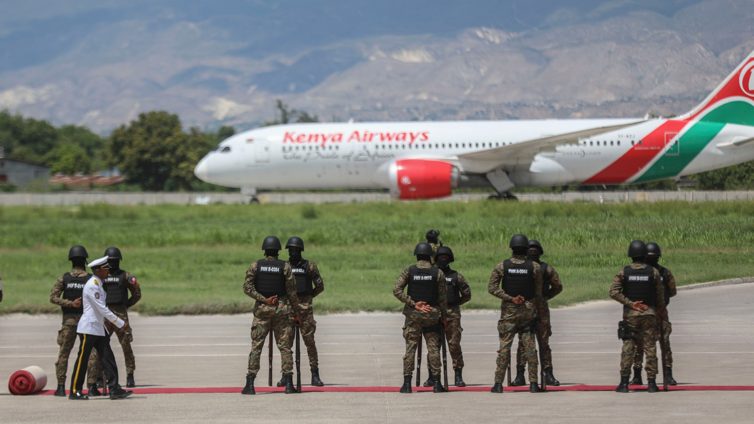 Kenyan police, part of a UN-backed multinational force, receive the plane transporting Kenya's President William Ruto, at their base in Port-au-Prince, Haiti, Saturday, Sept. 21, 2024. (AP Photo/Odelyn Joseph)