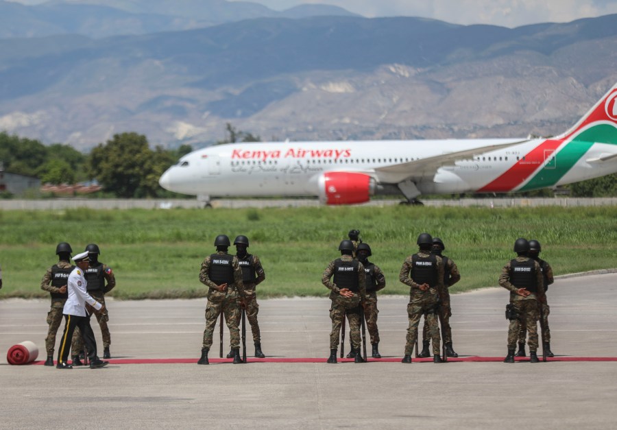 Kenyan police, part of a UN-backed multinational force, receive the plane transporting Kenya's President William Ruto, at their base in Port-au-Prince, Haiti, Saturday, Sept. 21, 2024. (AP Photo/Odelyn Joseph)