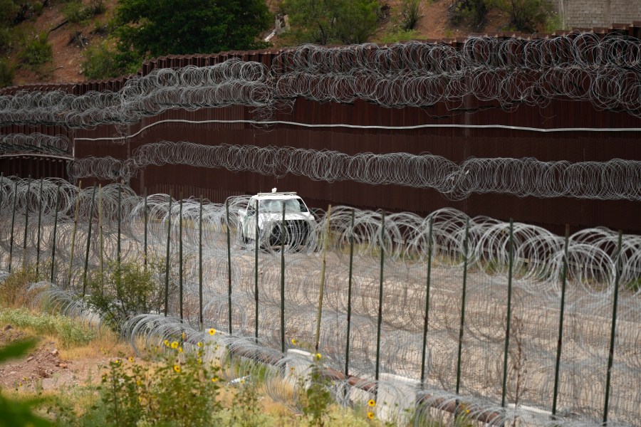 FILE - A vehicle drives along the U.S. side of the US-Mexico border wall in Nogales, Ariz., June 25, 2024. The Biden administration is making asylum restrictions at the southern border even tougher. The changes come in the middle of an election campaign where border security is a key concern for voters, and the administration is increasingly eager to show voters it's taking a hard stance. (AP Photo/Jae C. Hong, Pool, File)