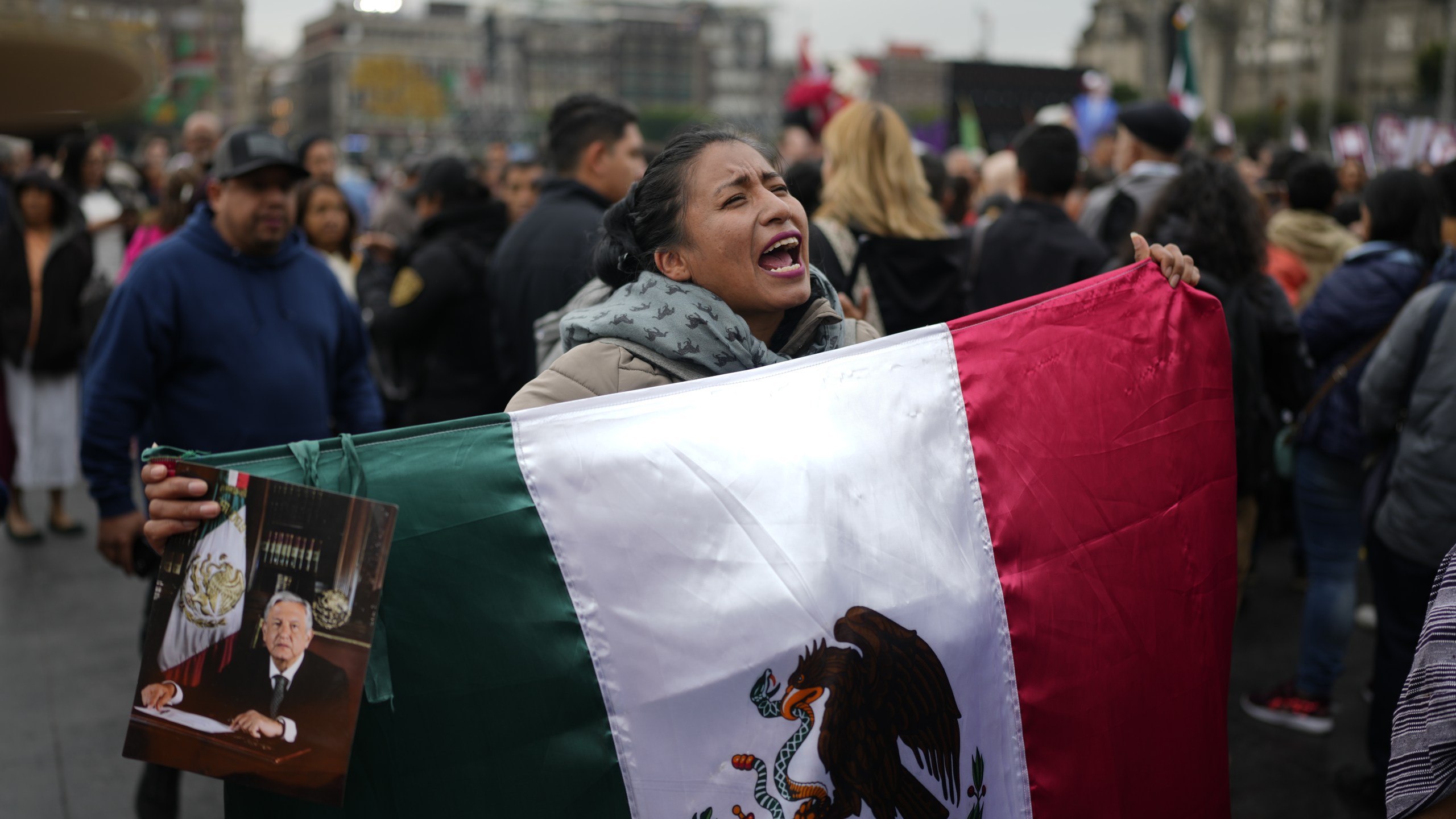 Supporters of Mexican President Andres Manuel Lopez Obrador gather outside the National Palace where he holds his last morning press conference, "La Mañanera," in Mexico City, Monday, Sept. 30, 2024. (AP Photo/Eduardo Verdugo)