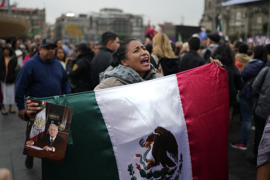 Supporters of Mexican President Andres Manuel Lopez Obrador gather outside the National Palace where he holds his last morning press conference, "La Mañanera," in Mexico City, Monday, Sept. 30, 2024. (AP Photo/Eduardo Verdugo)