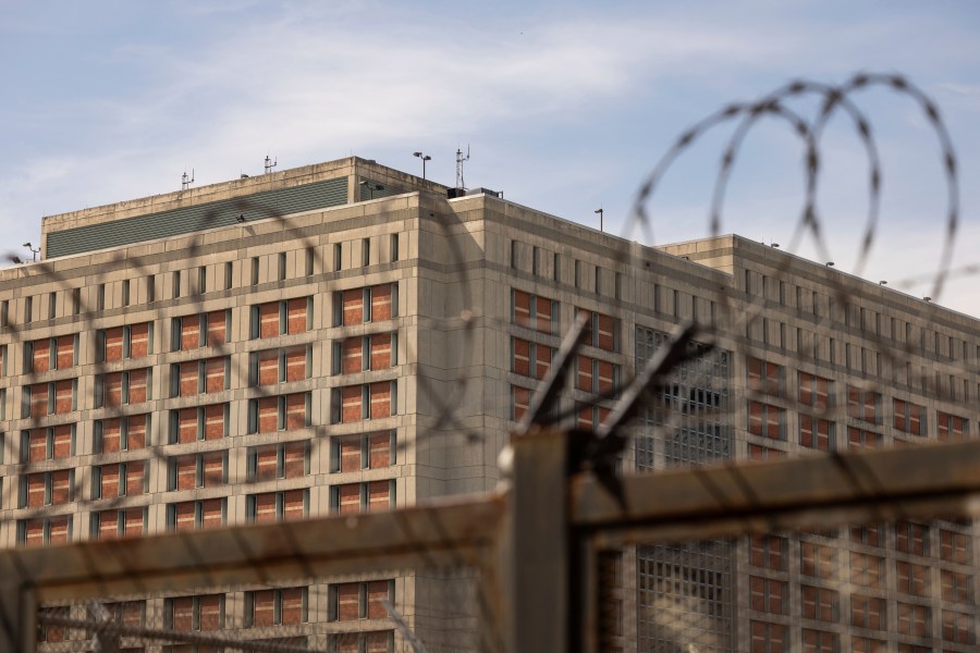 The Metropolitan Detention Center is seen through barb wire in the Sunset Park neighborhood of the Brooklyn borough of New York, Thursday, Sept. 19, 2024. (AP Photo/Yuki Iwamura)