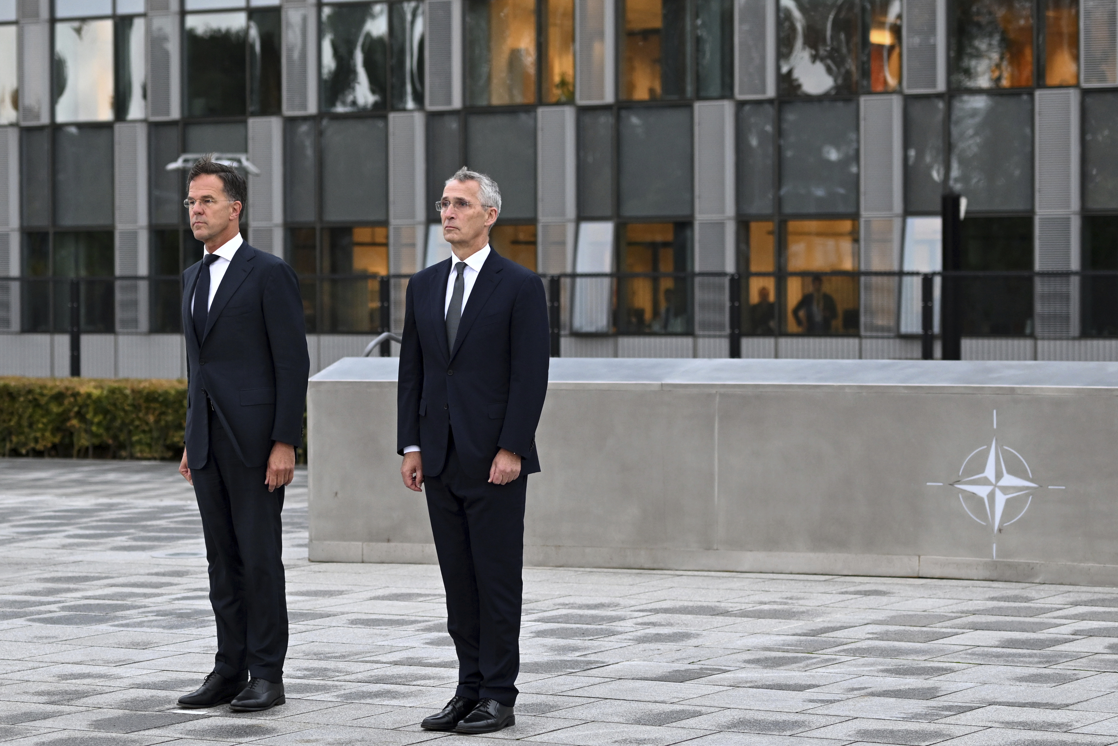 NATO Secretary General Jens Stoltenberg, right, and the incoming NATO Secretary General Mark Rutte stand during a wreath laying ceremony at NATO headquarters in Brussels, Belgium, Tuesday, Oct. 1, 2024. (AP Photo/Harry Nakos)