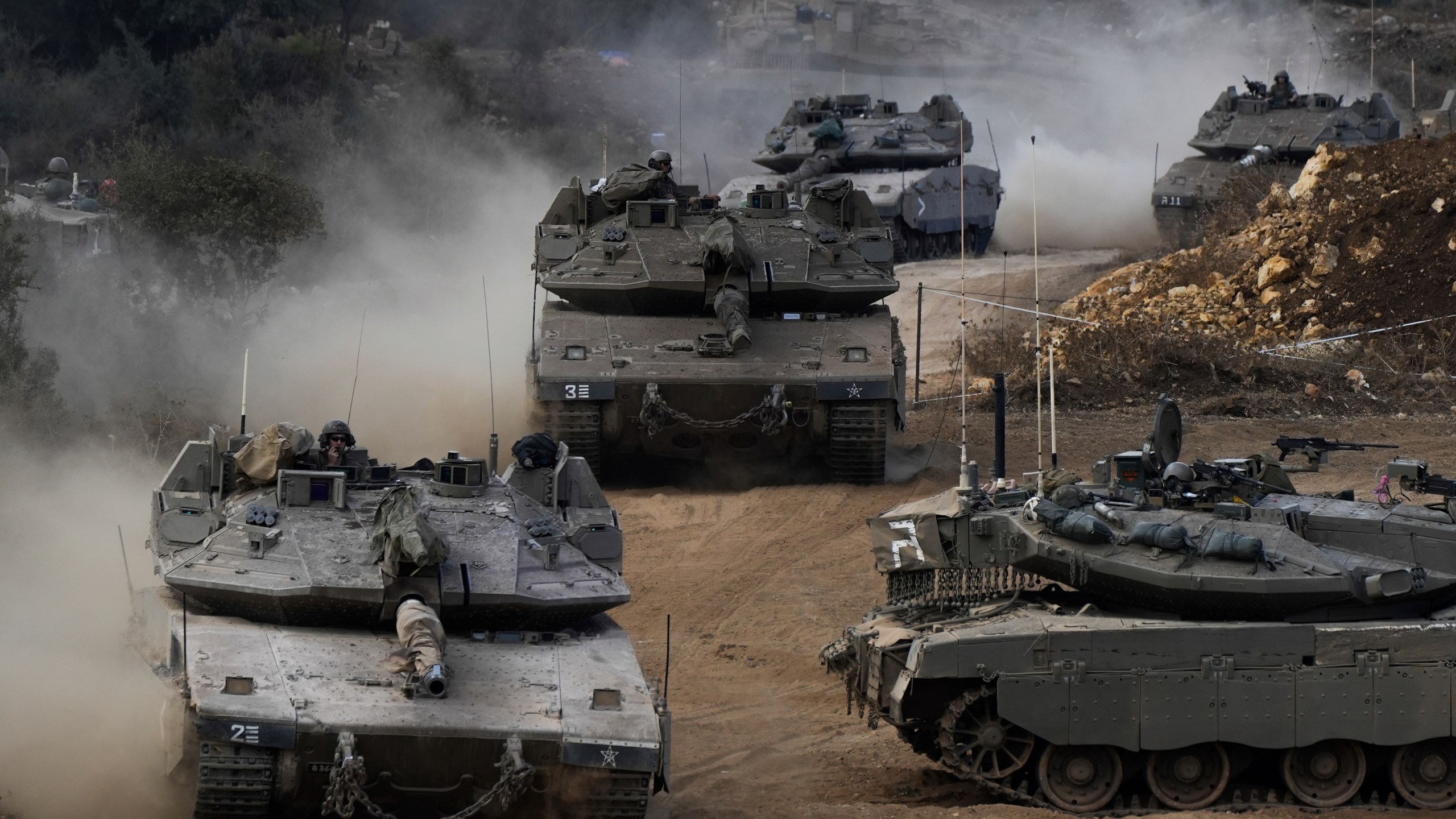 Israeli army tanks manoeuvre in a staging area in northern Israel near the Israel-Lebanon border, Tuesday, Oct. 1, 2024. (AP Photo/Baz Ratner)