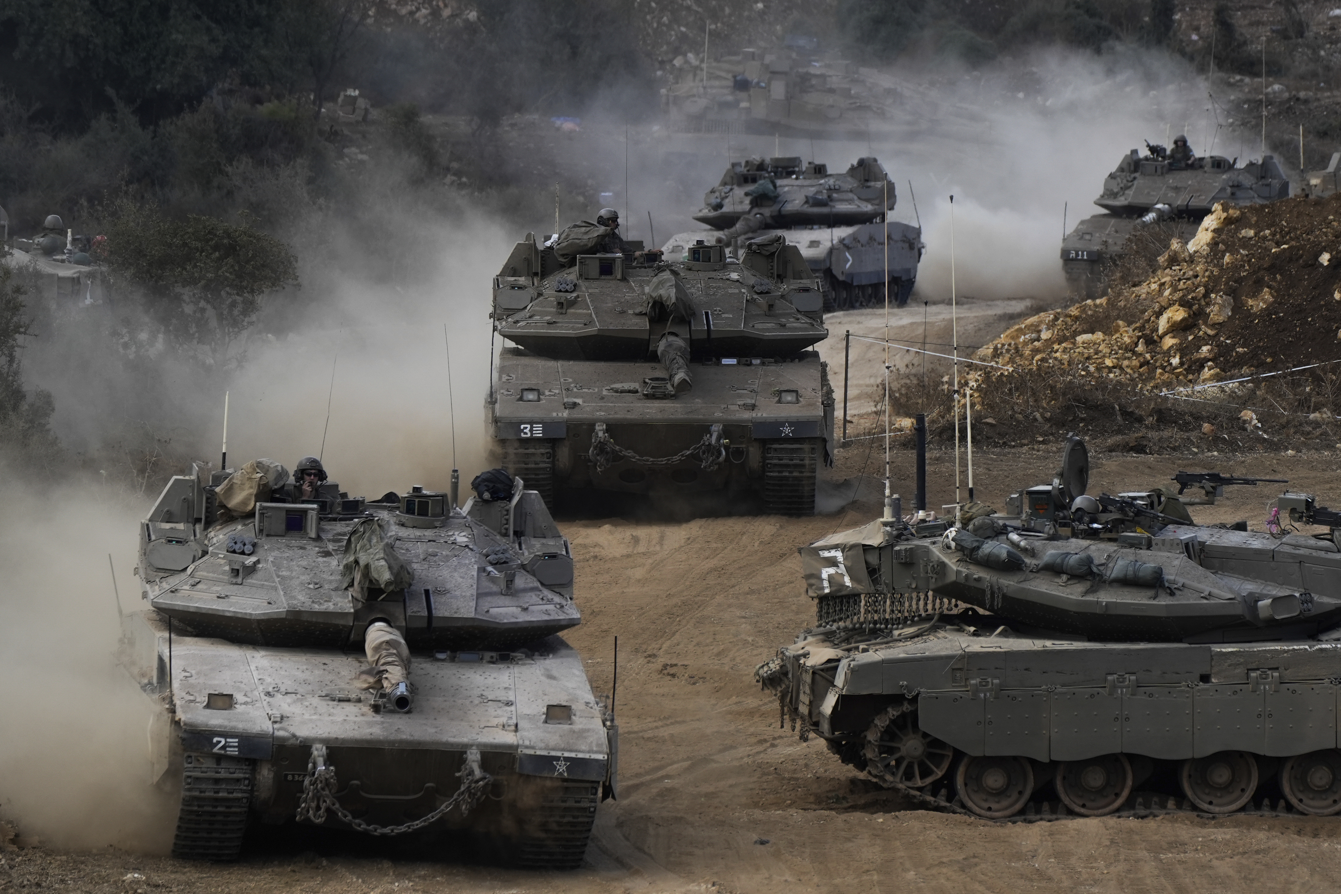 Israeli army tanks manoeuvre in a staging area in northern Israel near the Israel-Lebanon border, Tuesday, Oct. 1, 2024. (AP Photo/Baz Ratner)