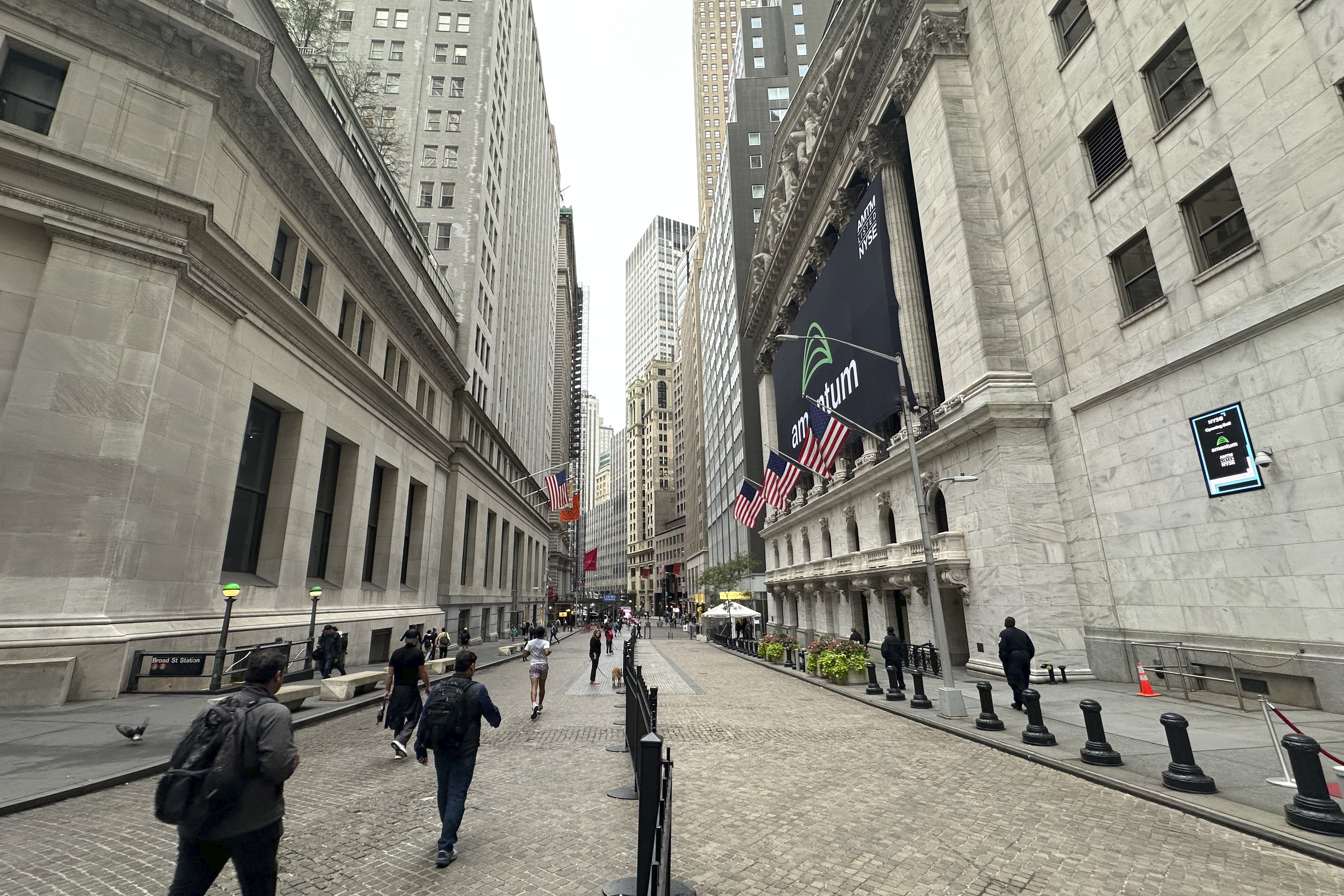 The New York Stock Exchange, right, is shown on Tuesday, Oct. 1, 2024, in New York. (AP Photo/Peter Morgan)