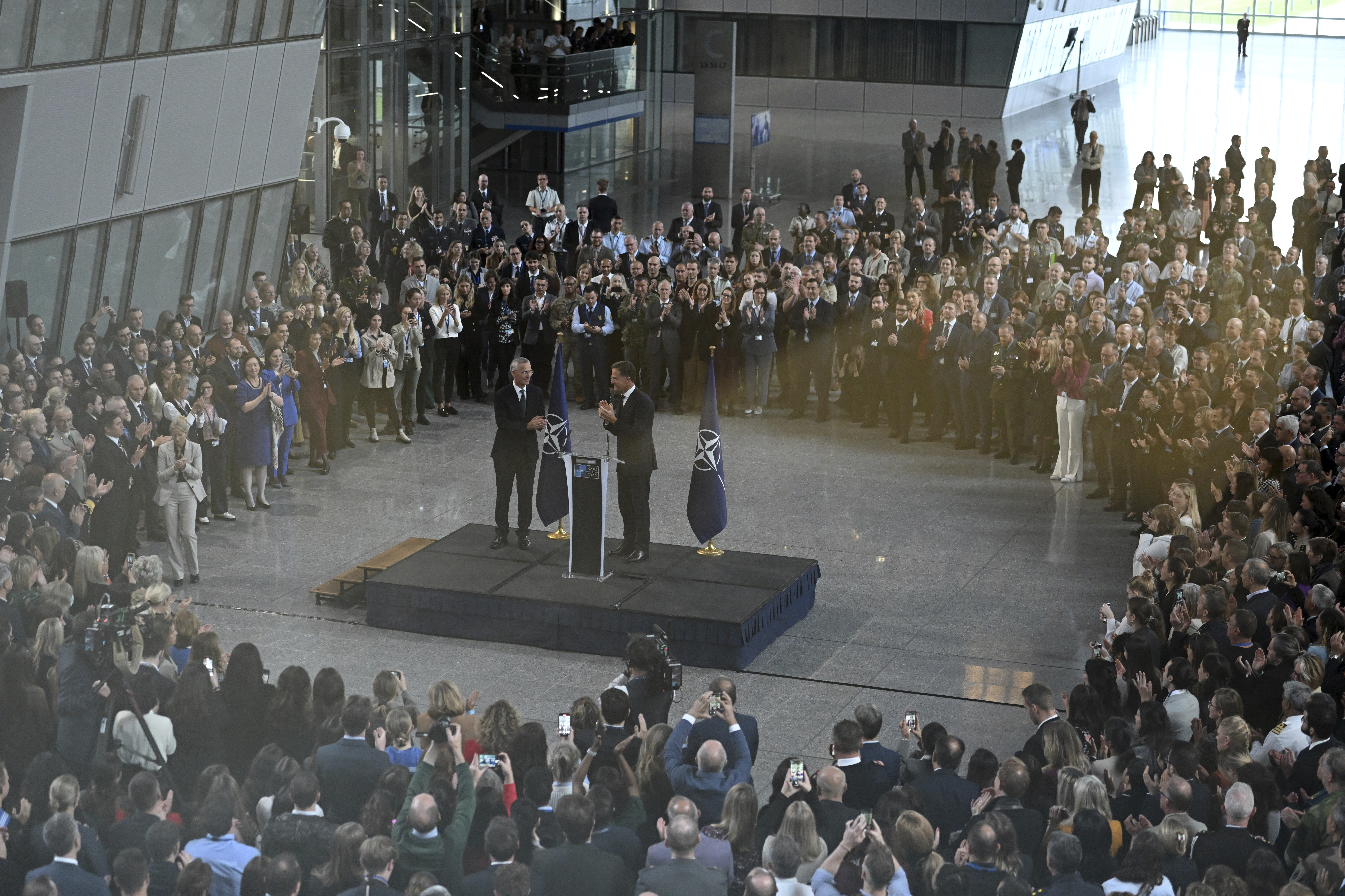 The new NATO Secretary General Mark Rutte, right, applauds the outgoing NATO Secretary General Jens Stoltenberg during a handover ceremony ce at NATO headquarters in Brussels, Belgium, Tuesday, Oct. 1, 2024. (AP Photo/Harry Nakos)