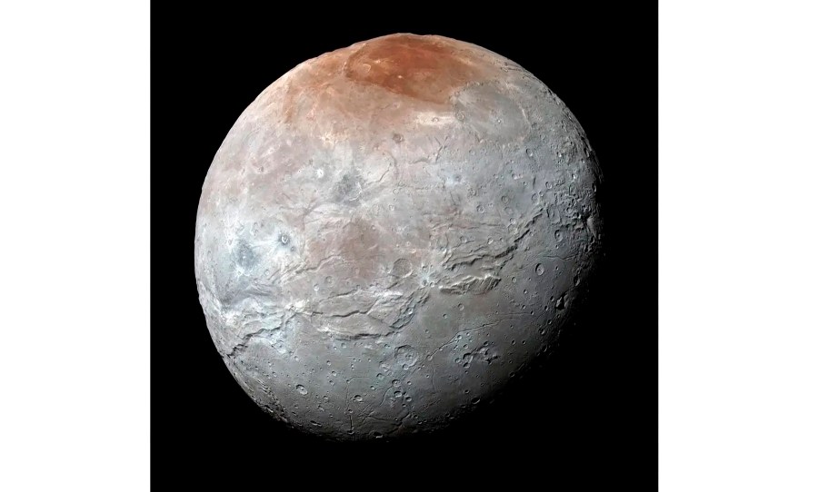 This image provided by NASA shows an enhanced color view of Pluto’s big moon Charon captured by the New Horizons spacecraft, July 14, 2015. (NASA via AP)