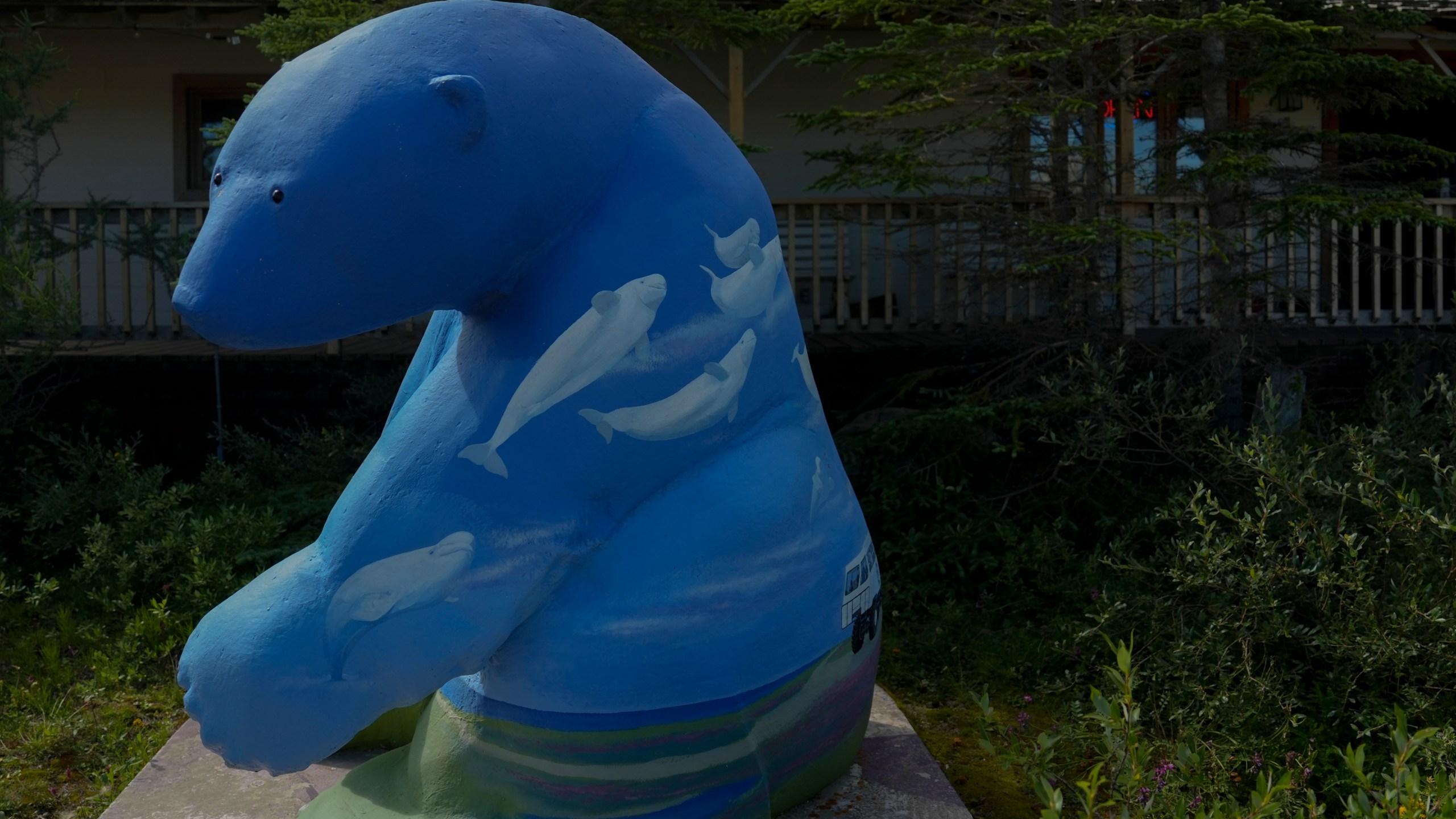 A polar bear statue with painted beluga whales sits outside a gift shop, Tuesday, Aug. 6, 2024, in Churchill, Manitoba. (AP Photo/Joshua A. Bickel)