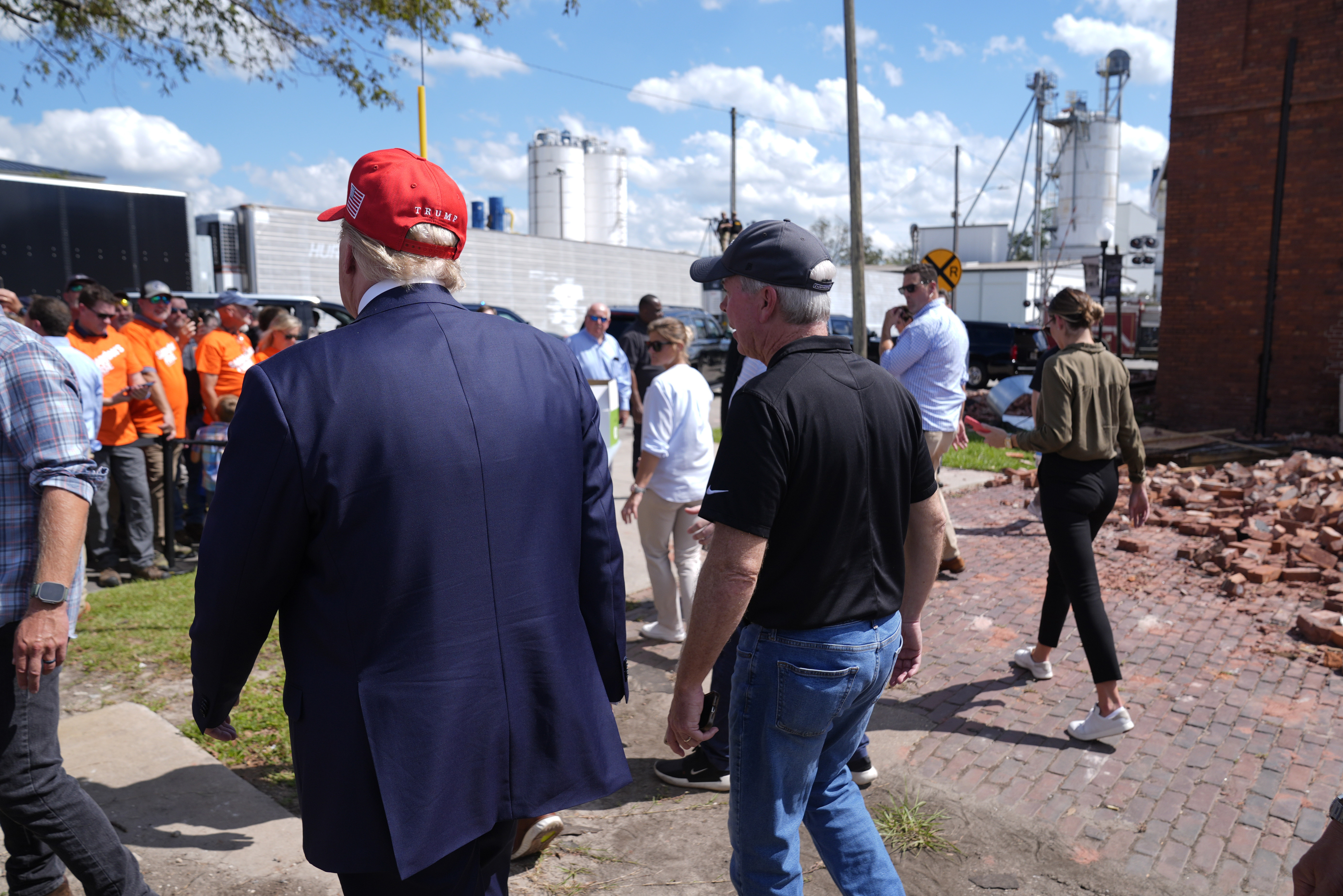 Republican presidential nominee former President Donald Trump walks outside the Chez What furniture store as he visits Valdosta, Ga., a town impacted by Hurricane Helene, Monday, Sept. 30, 2024. (AP Photo/Evan Vucci)