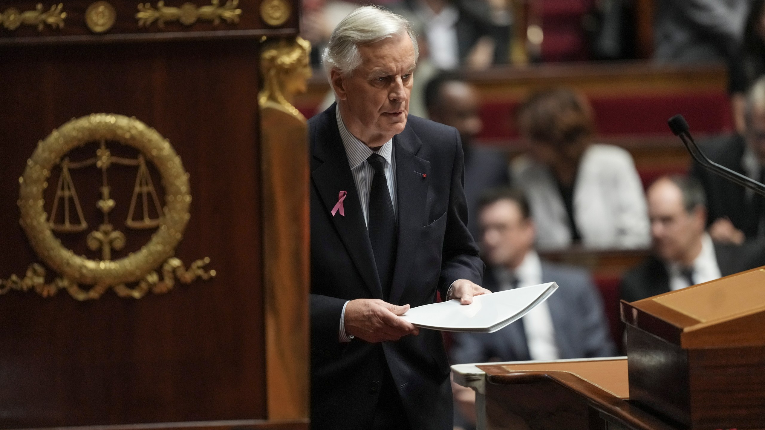 France's Prime Minister Michel Barnier arrives at stage to deliver a speech at the National Assembly, in Paris, Tuesday, Oct. 1, 2024. (AP Photo/Thibault Camus)