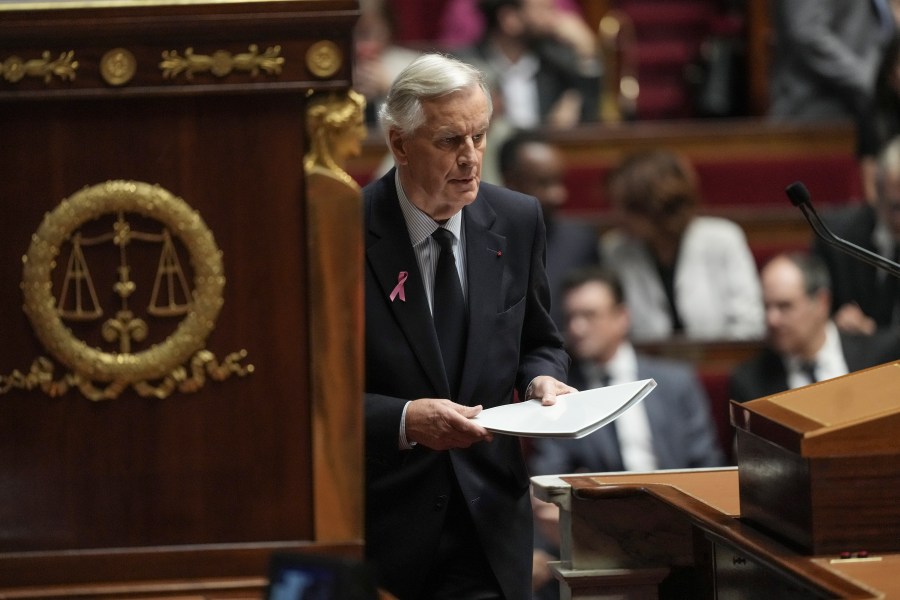 France's Prime Minister Michel Barnier arrives at stage to deliver a speech at the National Assembly, in Paris, Tuesday, Oct. 1, 2024. (AP Photo/Thibault Camus)