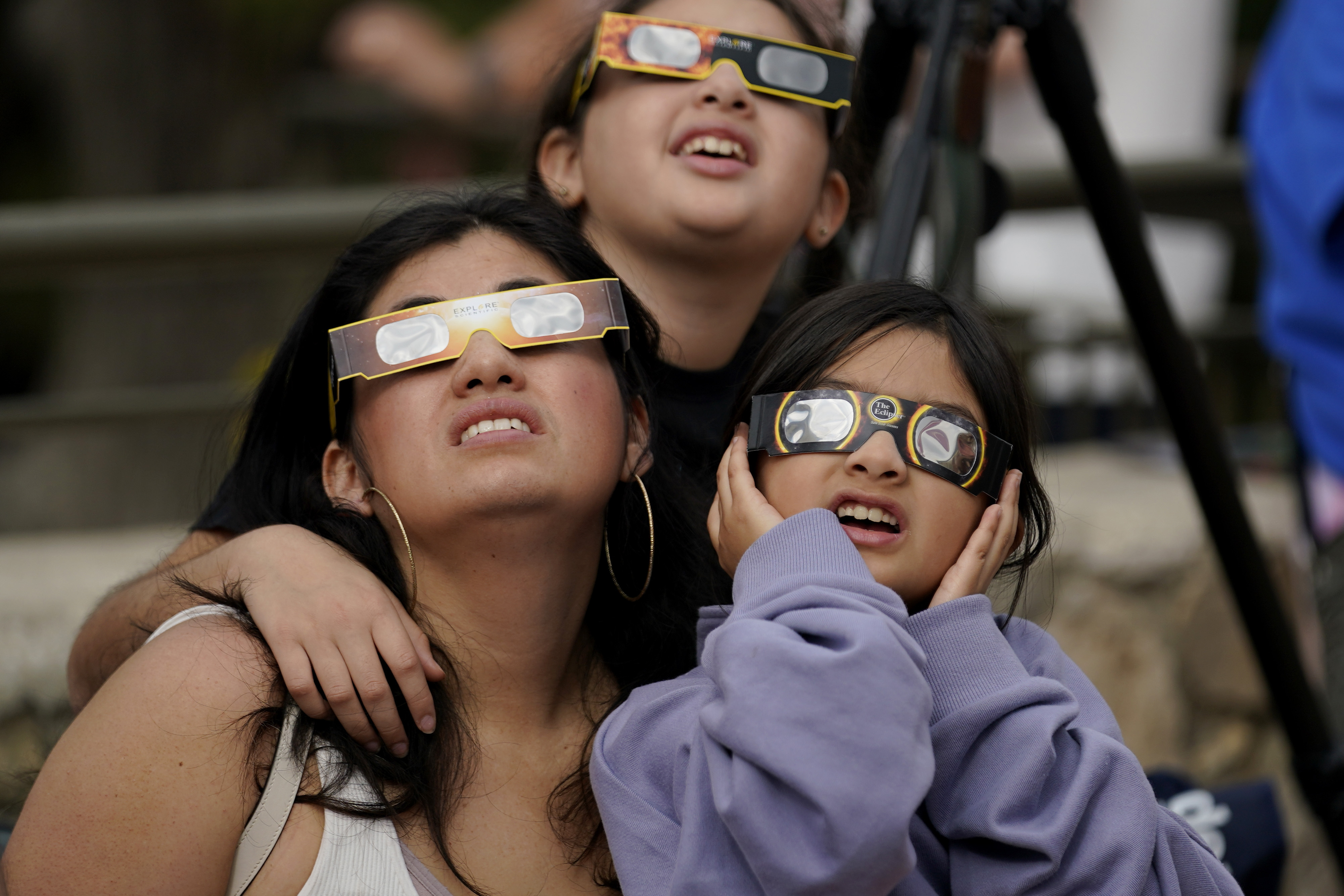 FILE - Viewers use special glasses to watch as the moon moves in front of the sun during an annular solar eclipse, or ring of fire, Saturday, Oct. 14, 2023, as seen from San Antonio. (AP Photo/Eric Gay, File)