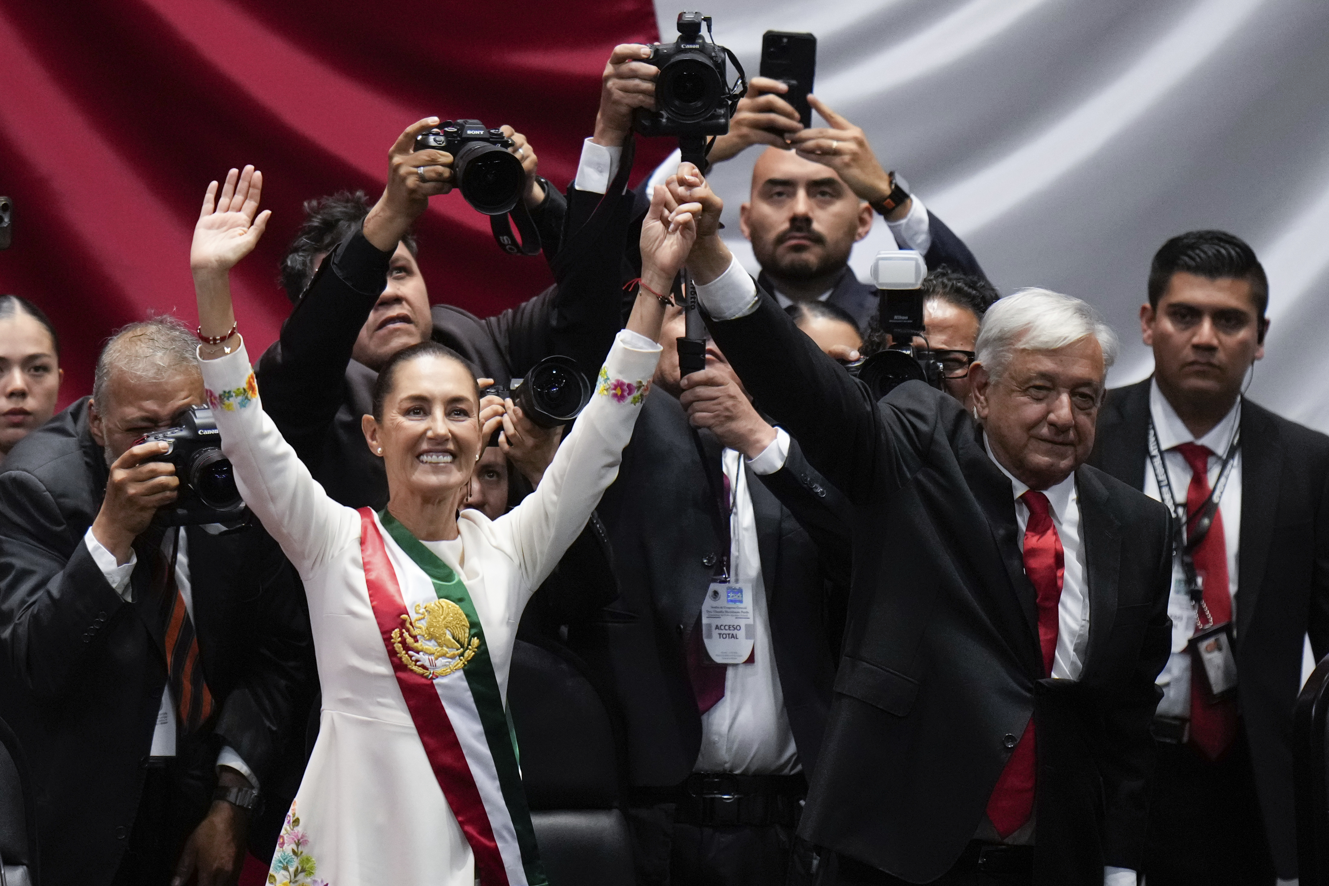 President Claudia Sheinbaum and outgoing President Andres Manuel López Obrador wave on her inauguration day at Congress in Mexico City, Tuesday, Oct. 1, 2024. (AP Photo/Eduardo Verdugo)