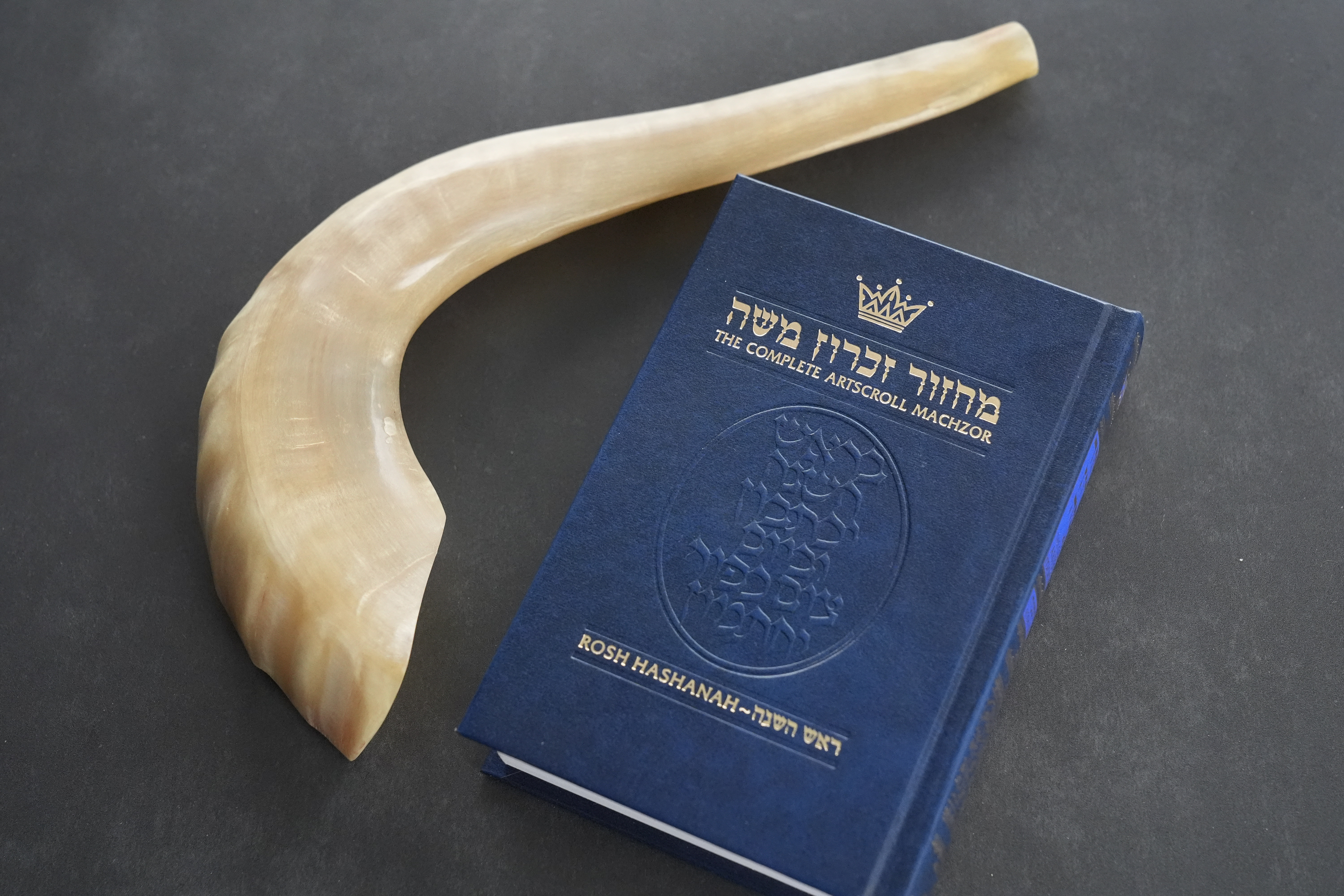 A shofar and a prayer book that Daniel Gammerman will use to privately celebrate the Jewish High Holy Days at home, are shown, Thursday, Sept. 26, 2024, in Miami. (AP Photo/Wilfredo Lee)