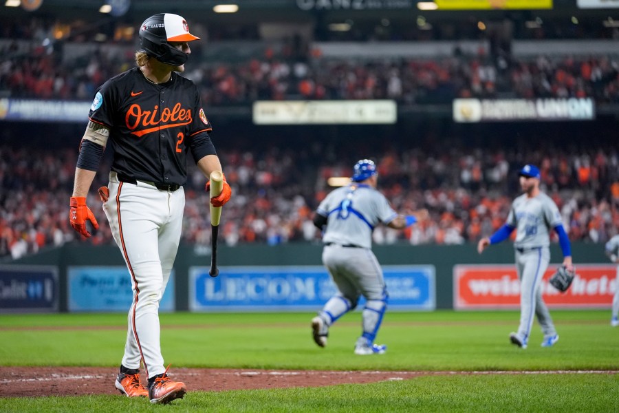 Baltimore Orioles' Gunnar Henderson, left, walks to the dugout after striking out for the final out as Kansas City Royals pitcher Lucas Erceg, right, and catcher Salvador Perez react following Game 2 of an AL Wild Card Series baseball game, Wednesday, Oct. 2, 2024 in Baltimore. The Royals won 2-1. (AP Photo/Stephanie Scarbrough)