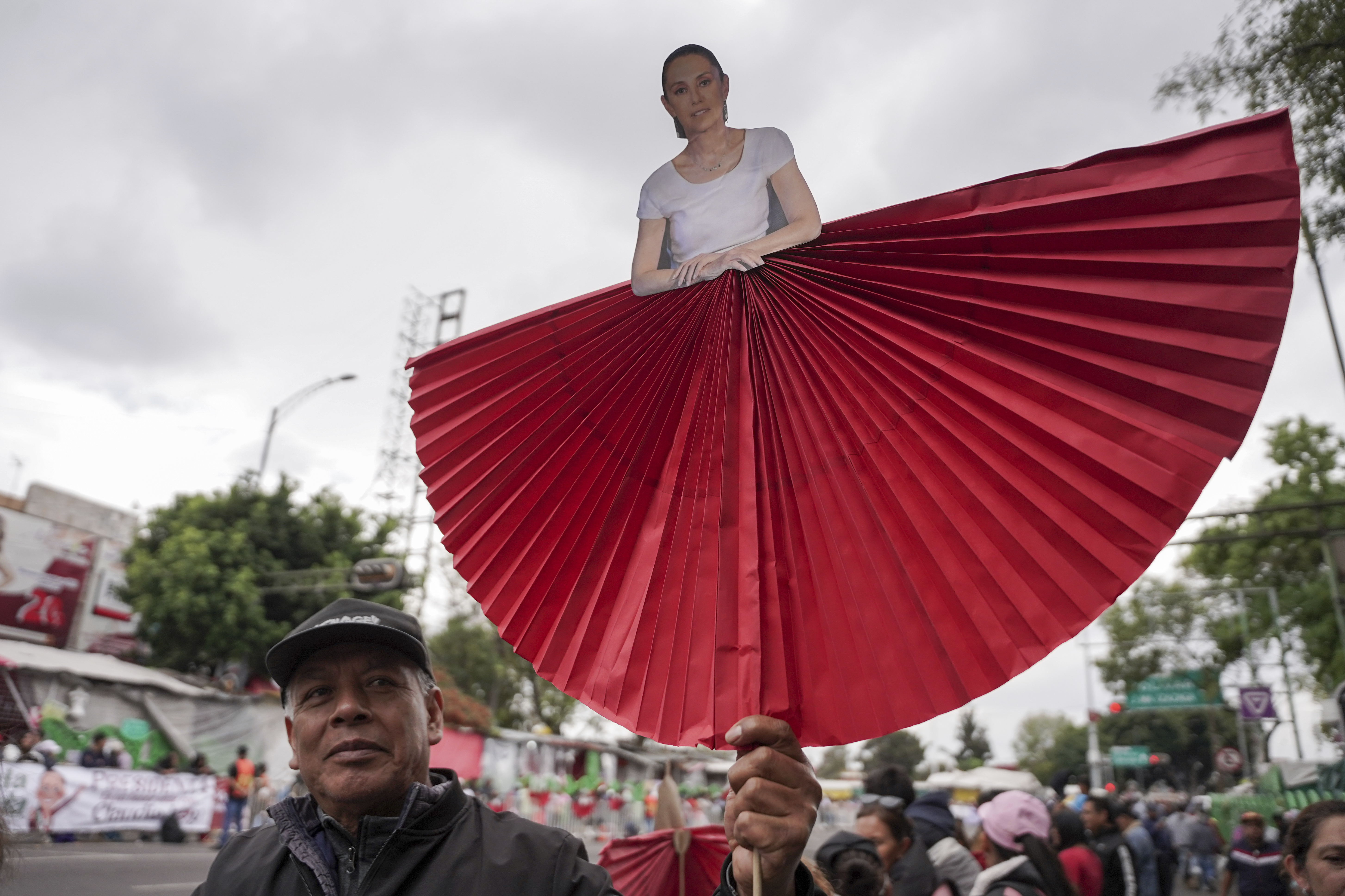 A supporter carries a cutout of President Claudia Sheinbaum during a rally to hear her speak on her inauguration day at the Zocalo, Mexico City's main square, Tuesday, Oct. 1, 2024. (AP Photo/Aurea Del Rosario)