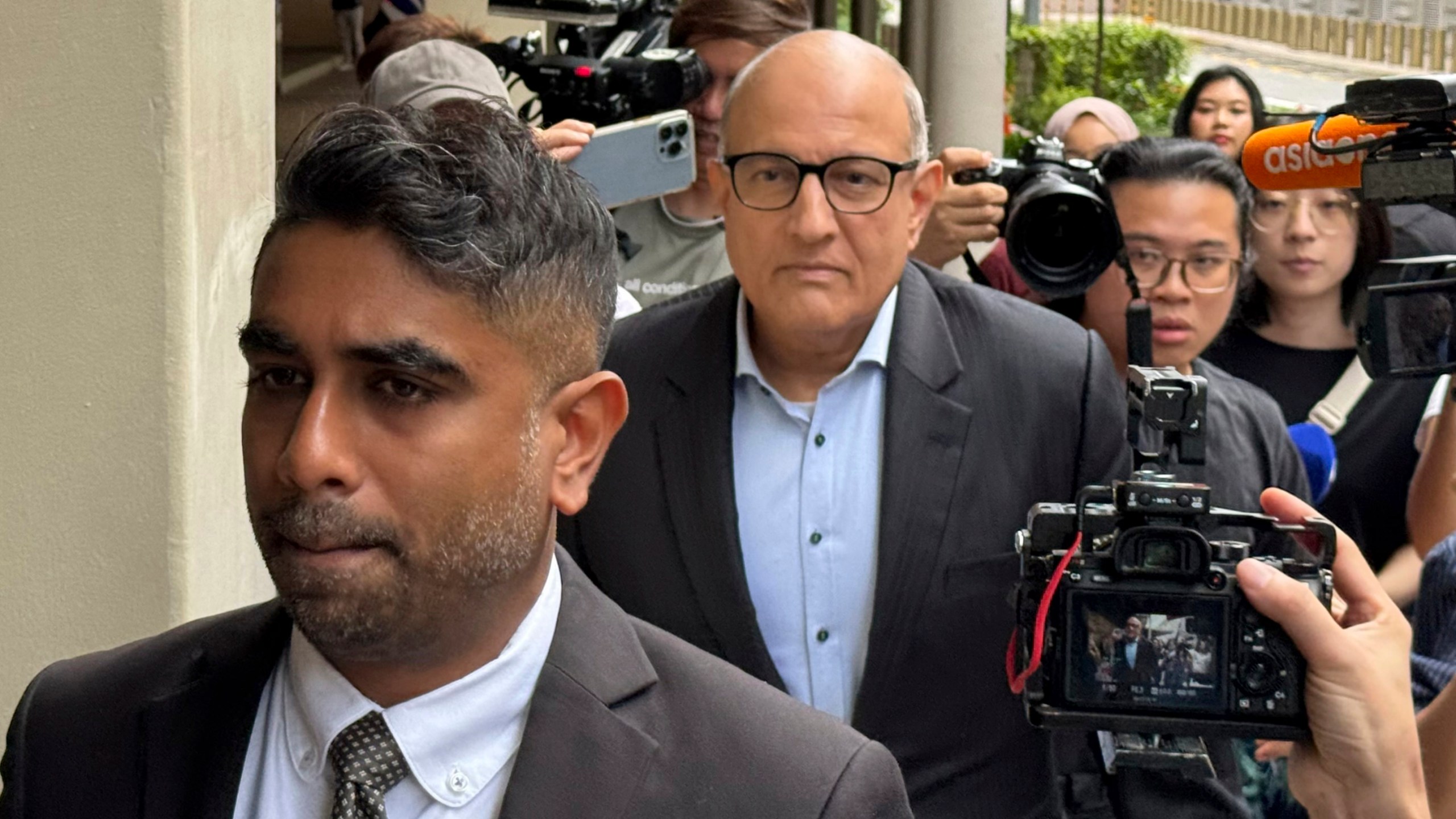 Former Transport Minister S. Iswaran, center, and his lawyer Navin Thevar arrive at the High Court in Singapore, July 5, 2024. (AP Photo)