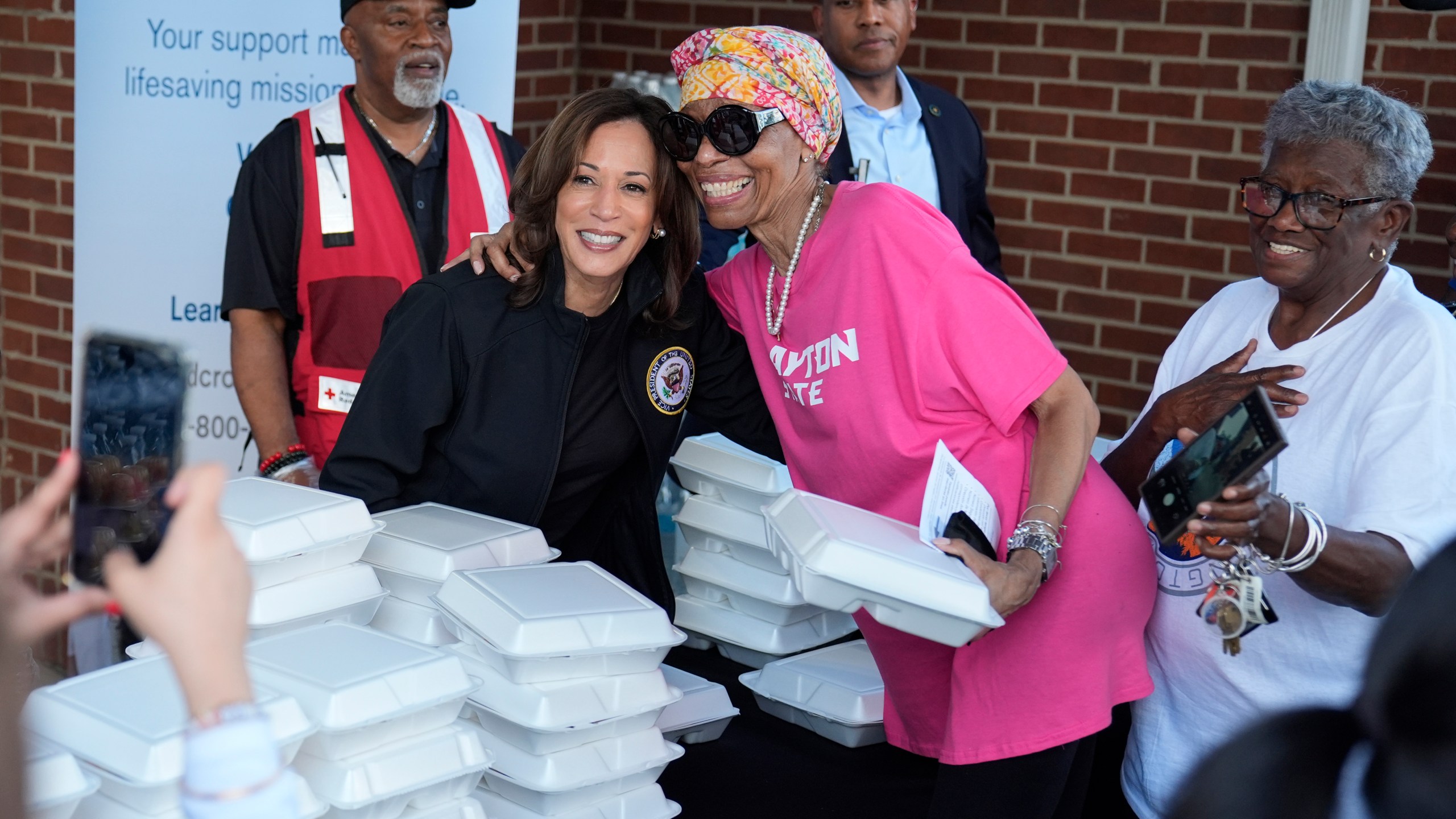 Democratic presidential nominee Vice President Kamala Harris poses for a photo as she helps distribute food with the American Red Cross at the Henry Brigham Community Center in Augusta, Ga., Wednesday, Oct. 2, 2024. (AP Photo/Carolyn Kaster)