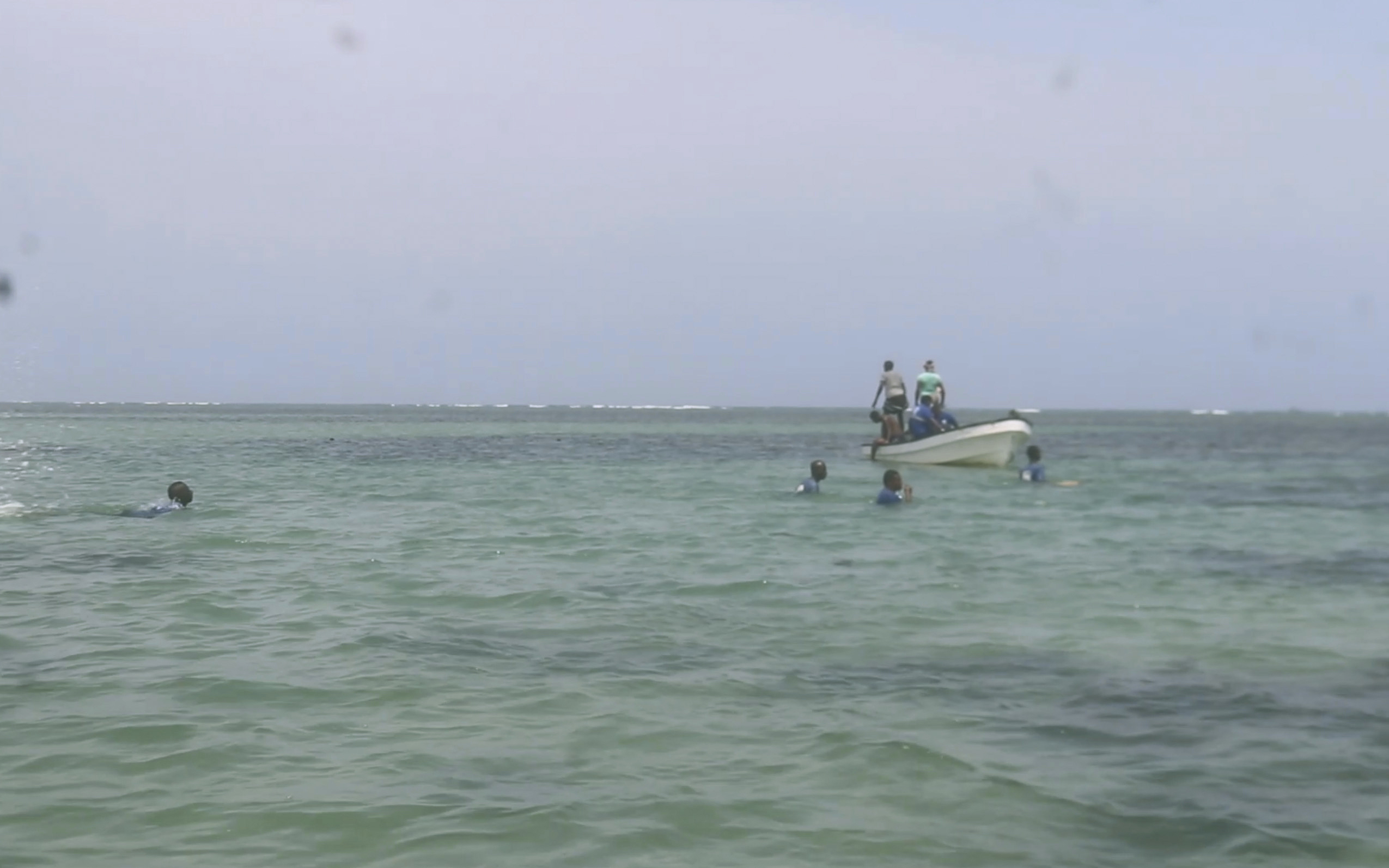 In this image made from video, Djiboutian coast guard workers search for bodies of migrants who were washed away on the shore of the Red Sea, off the coast in Djibouti Wednesday, Oct. 2, 2024. ( Djiboutian Coast Guard via AP)