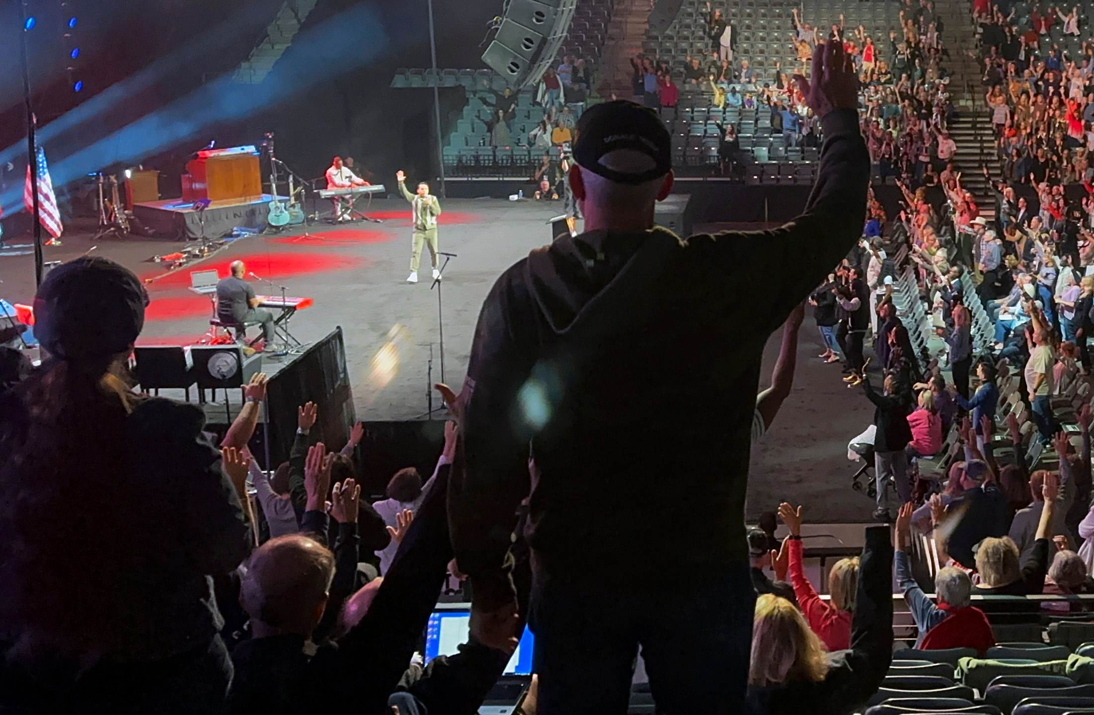 Audience members raise their hands in agreement with speaker Samuel Rodriguez, lead pastor of New Season church in Sacramento, Calif., at the Opening the Heavens conference on Friday, Sept. 13, 2024, at the Mid-America Center in Council Bluffs, Iowa. (AP Photo/Peter Smith)