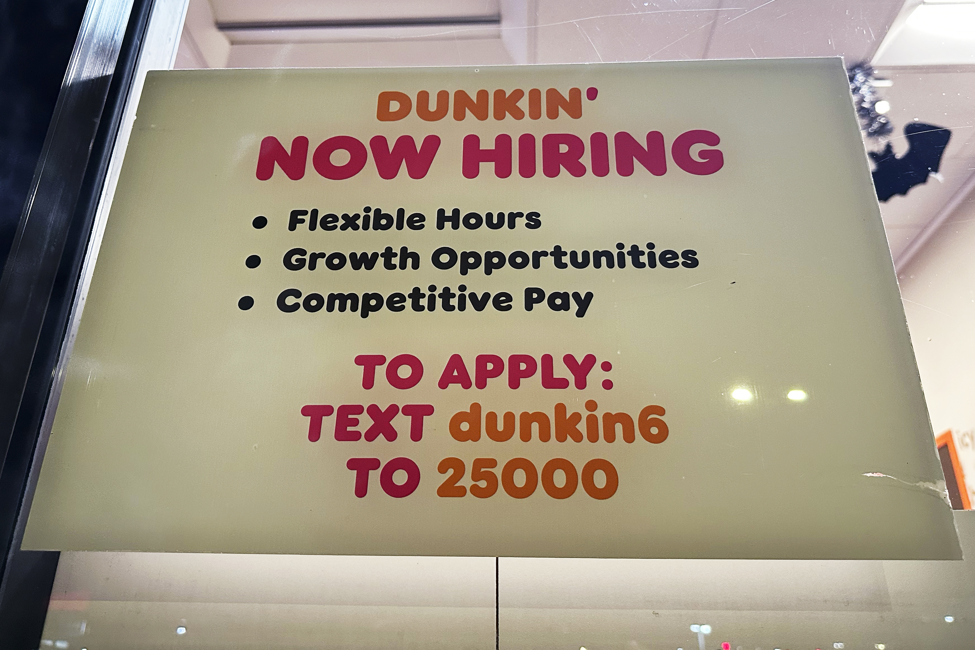 A hiring sign is displayed at a Dunkin' in Glenview, Ill., Tuesday, October. 1, 2024. (AP Photo/Nam Y. Huh)