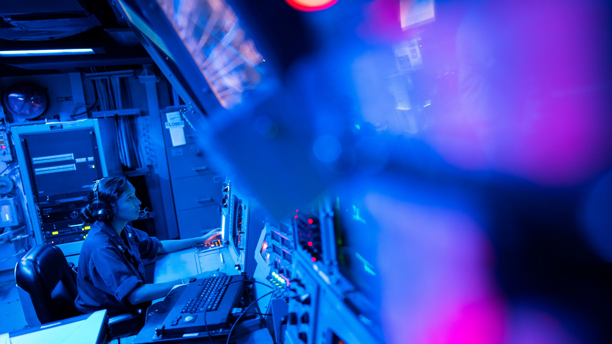 FILE -Crew members work in the combat information center of the Arleigh Burke-class guided missile destroyer USS Laboon during a deployment in the Red Sea, June 12, 2024. (AP Photo/Bernat Armangue, File)