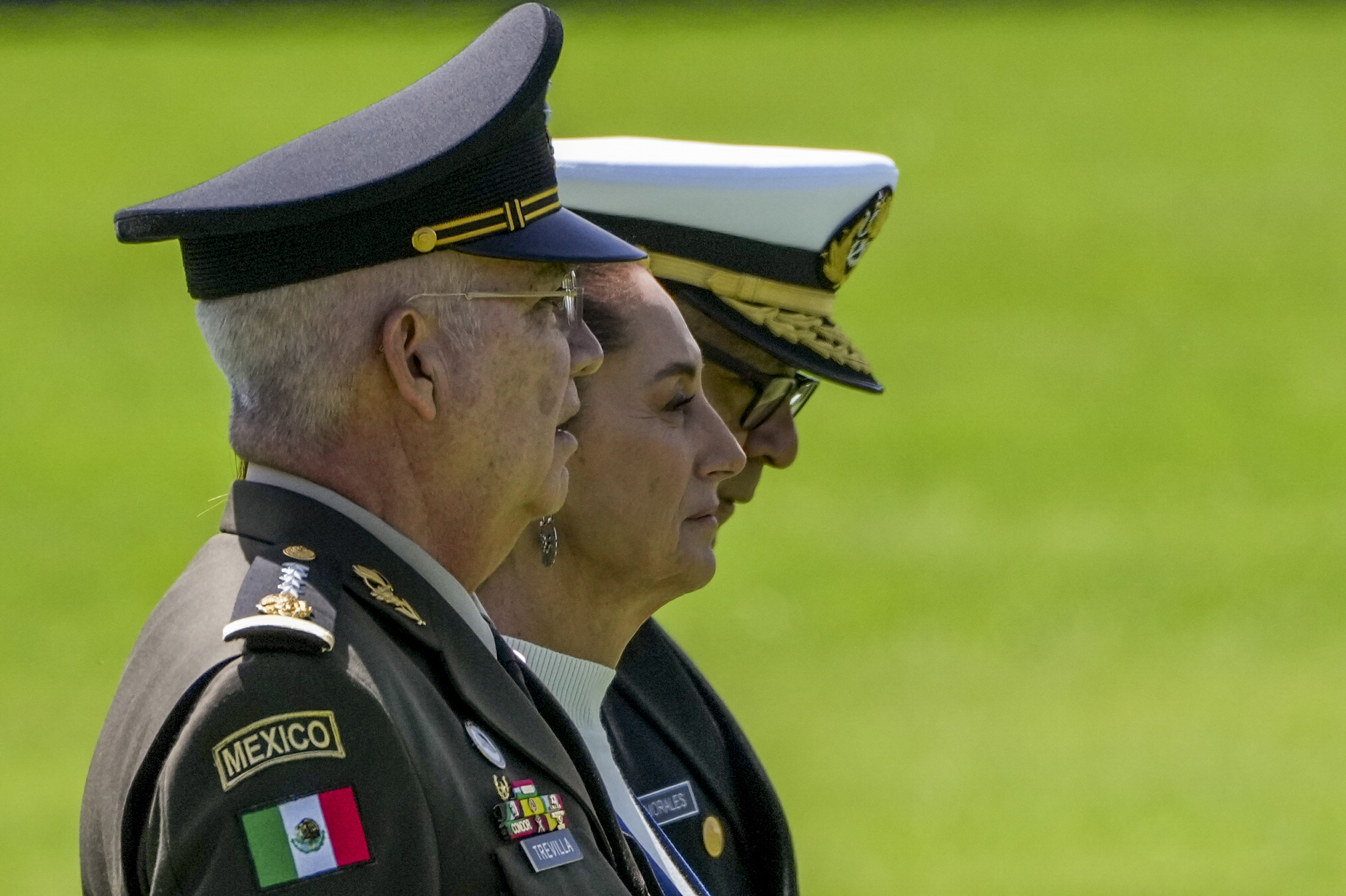 Mexican President Claudia Sheinbaum, center, reviews the troops with Defense Minister Gen. Ricardo Trevilla Trejo, left, and Navy Secretary Alt. Raymundo Pedro Morales at Campo Marte in Mexico City, Thursday, Oct. 3, 2024. (AP Photo/Fernando Llano)