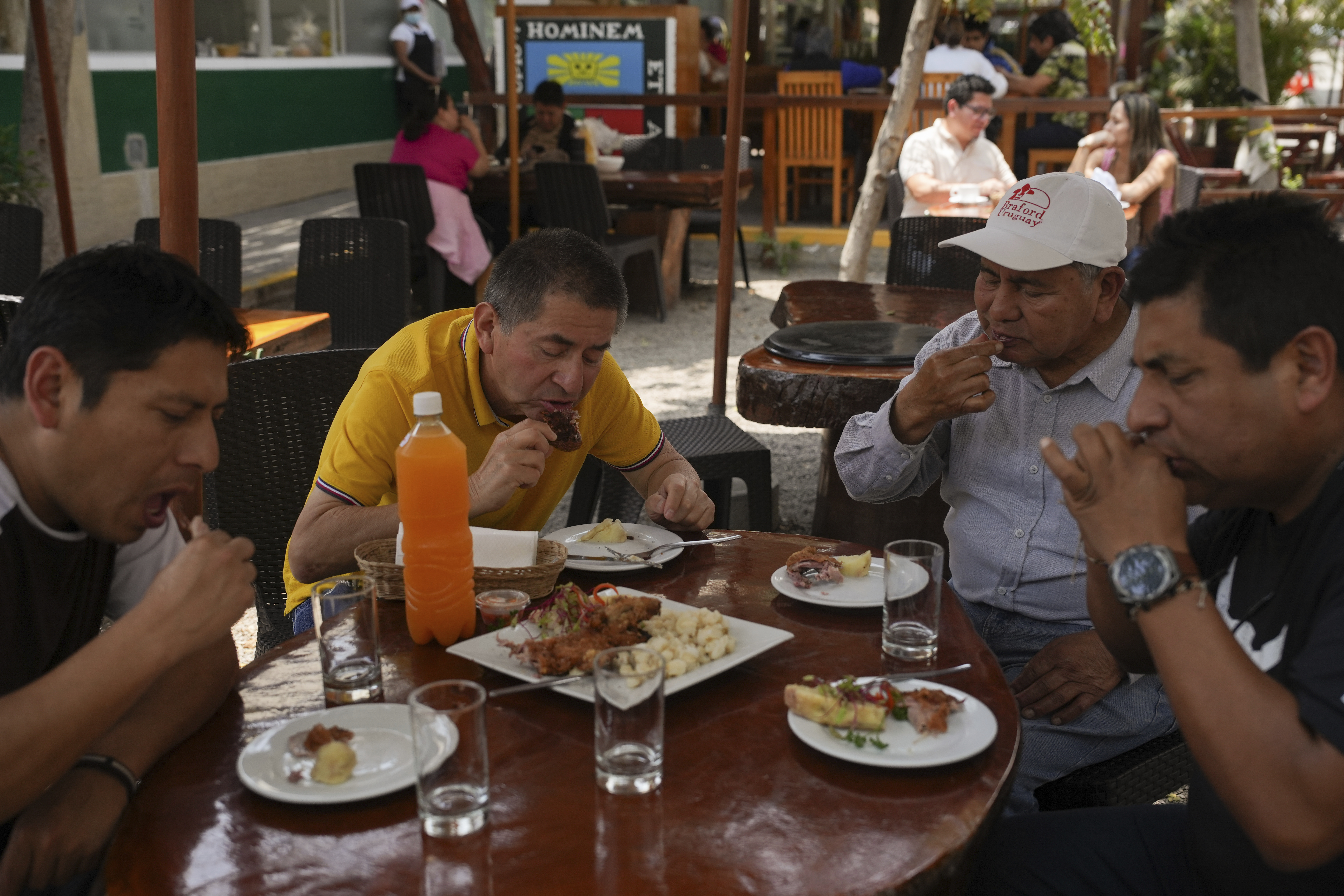 Costumers eat guinea pig at a restaurant in Lima, Peru, Thursday, Oct. 3, 2024. Guinea pigs, locally known as 'cuy,' have been traditionally raised for meat consumption since pre-Inca times. (AP Photo/Guadalupe Pardo)