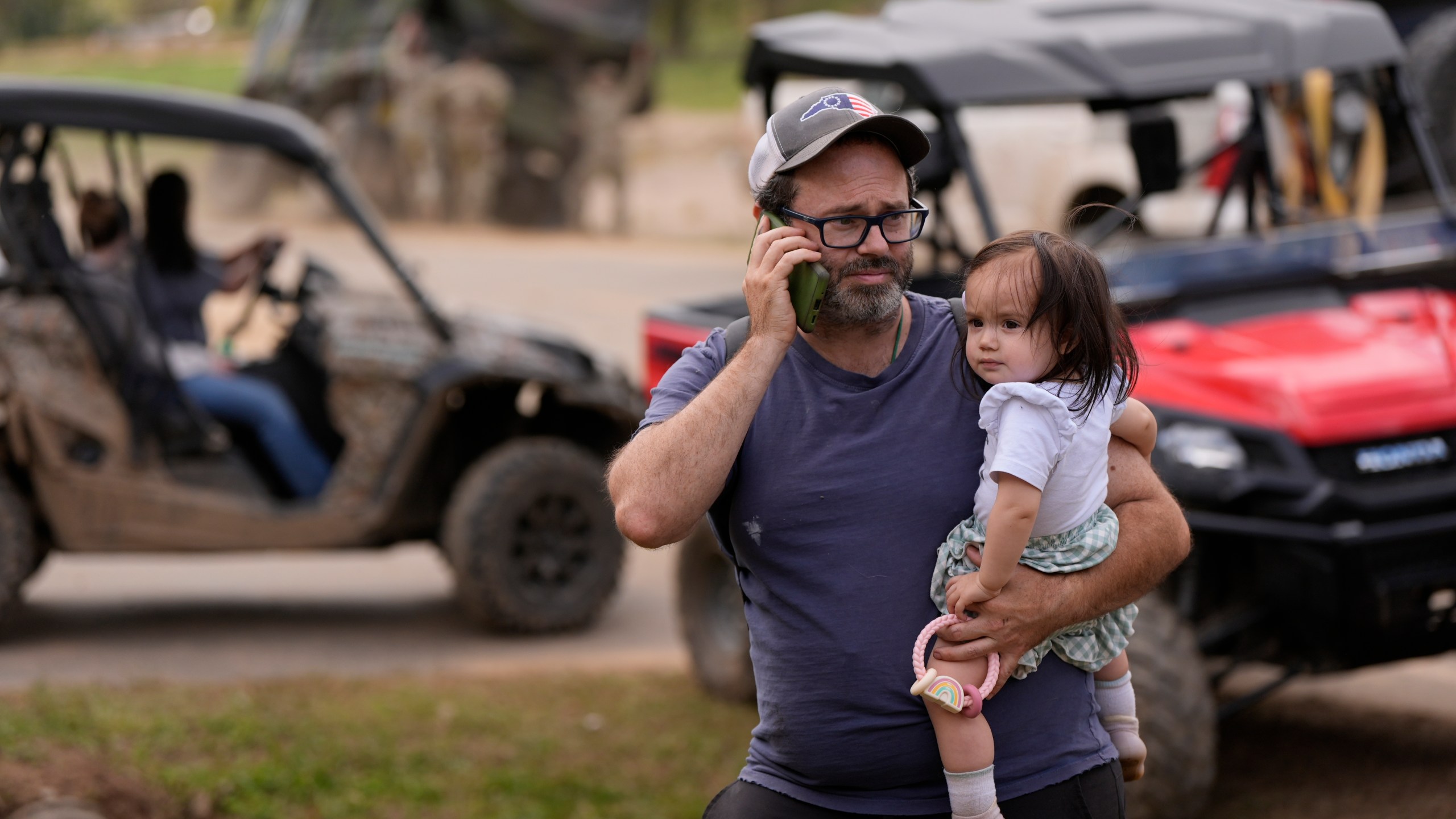 A man makes a call on the wireless system set up at the volunteer fire department in the aftermath of Hurricane Helene, Thursday, Oct. 3, 2024, in Pensacola, N.C. (AP Photo/Mike Stewart)